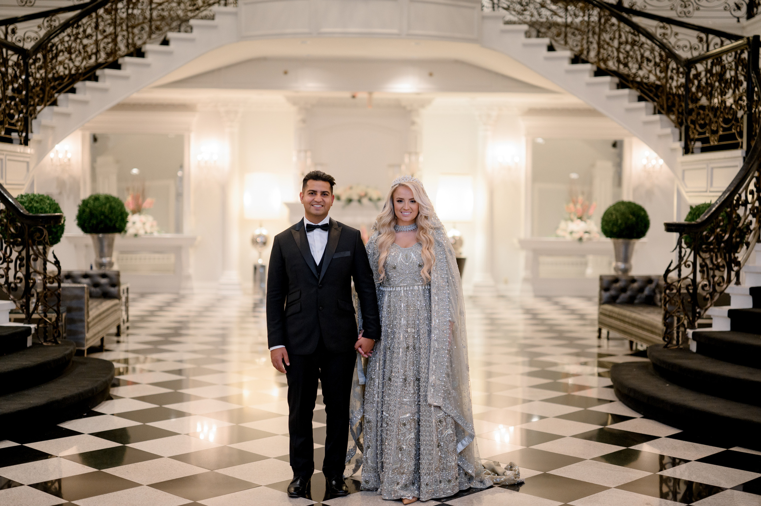 a bride and groom standing in a lobby