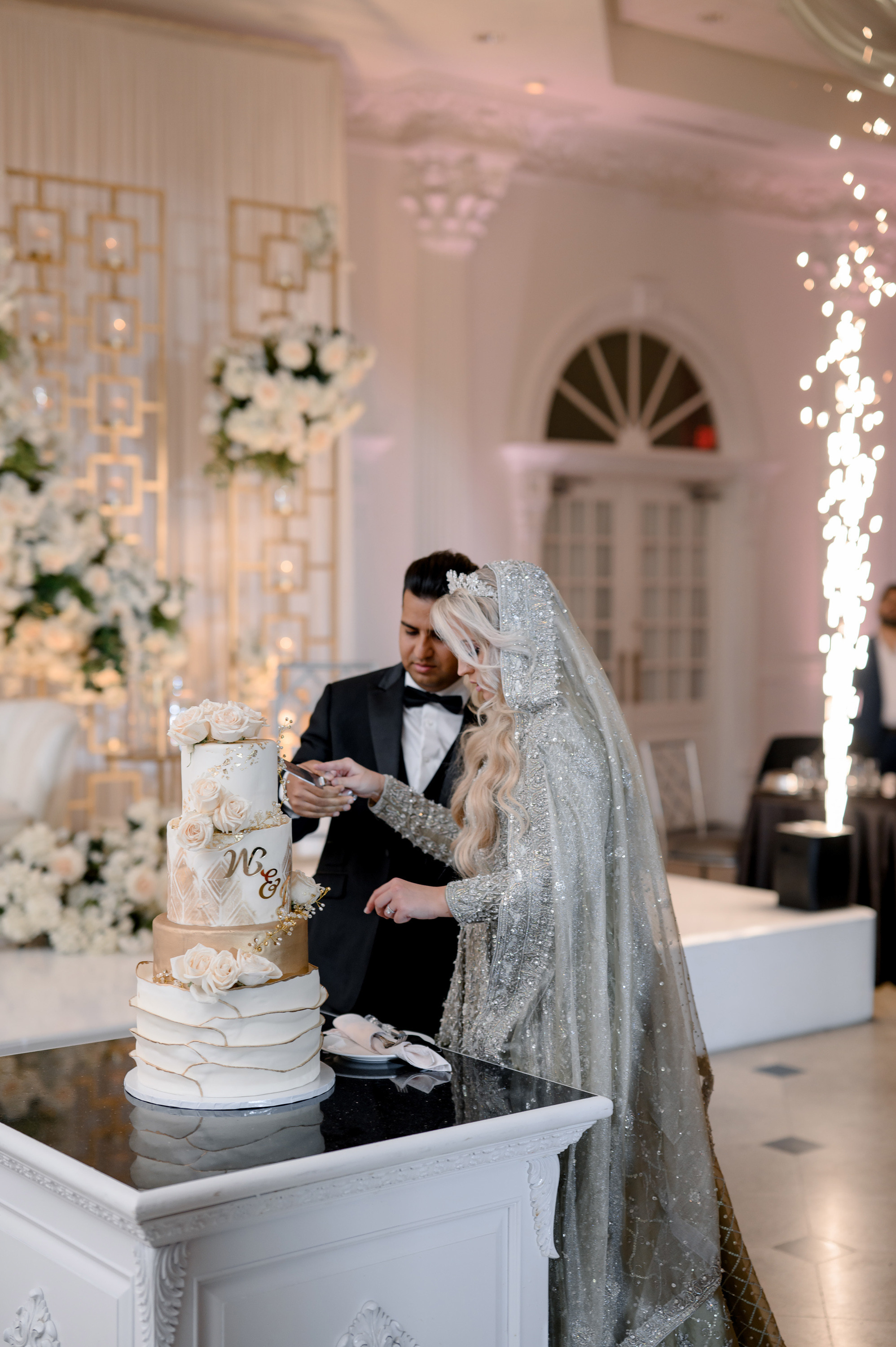 a bride and groom cutting a wedding cake