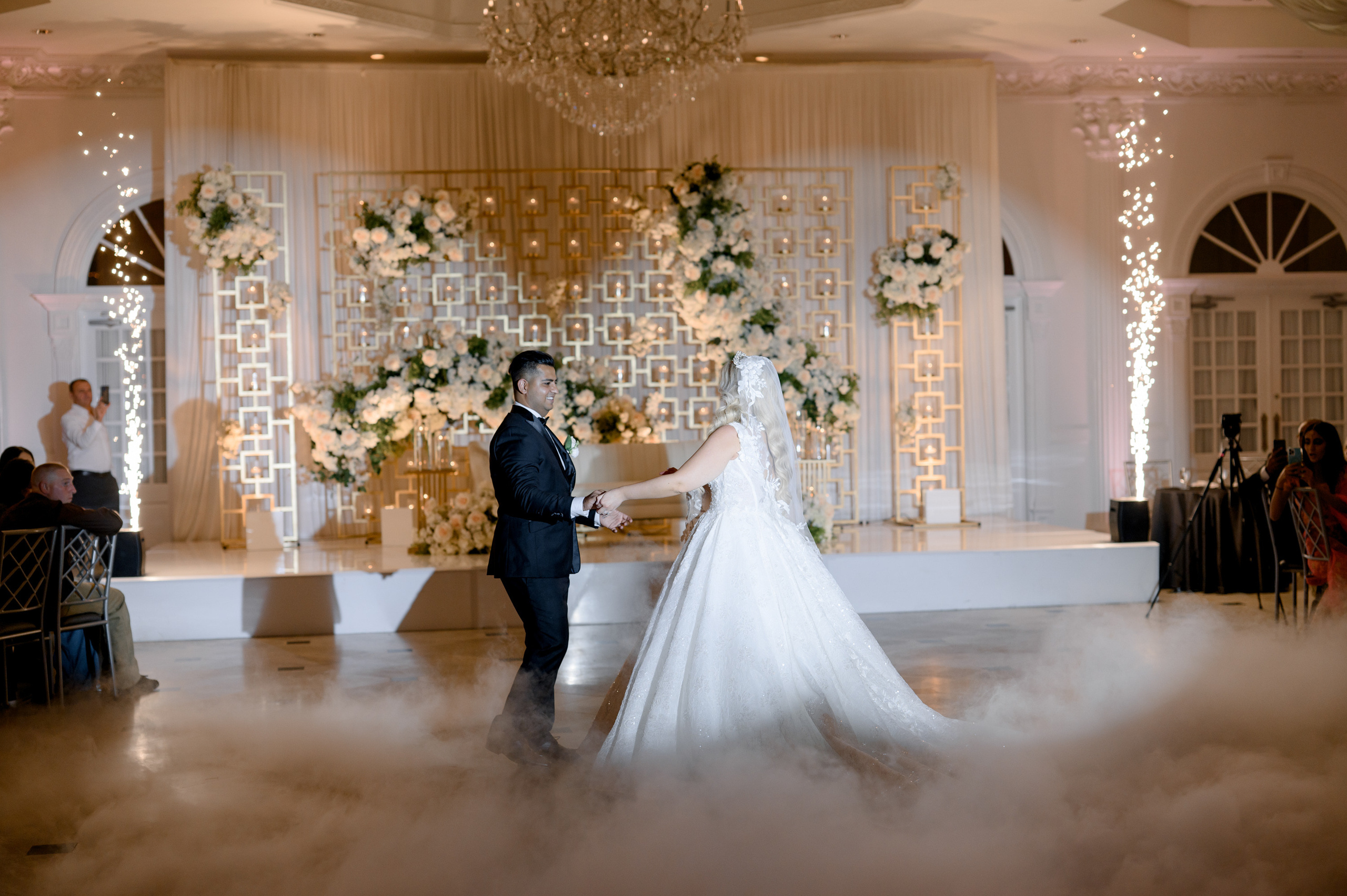 a bride and groom are standing in the clouds