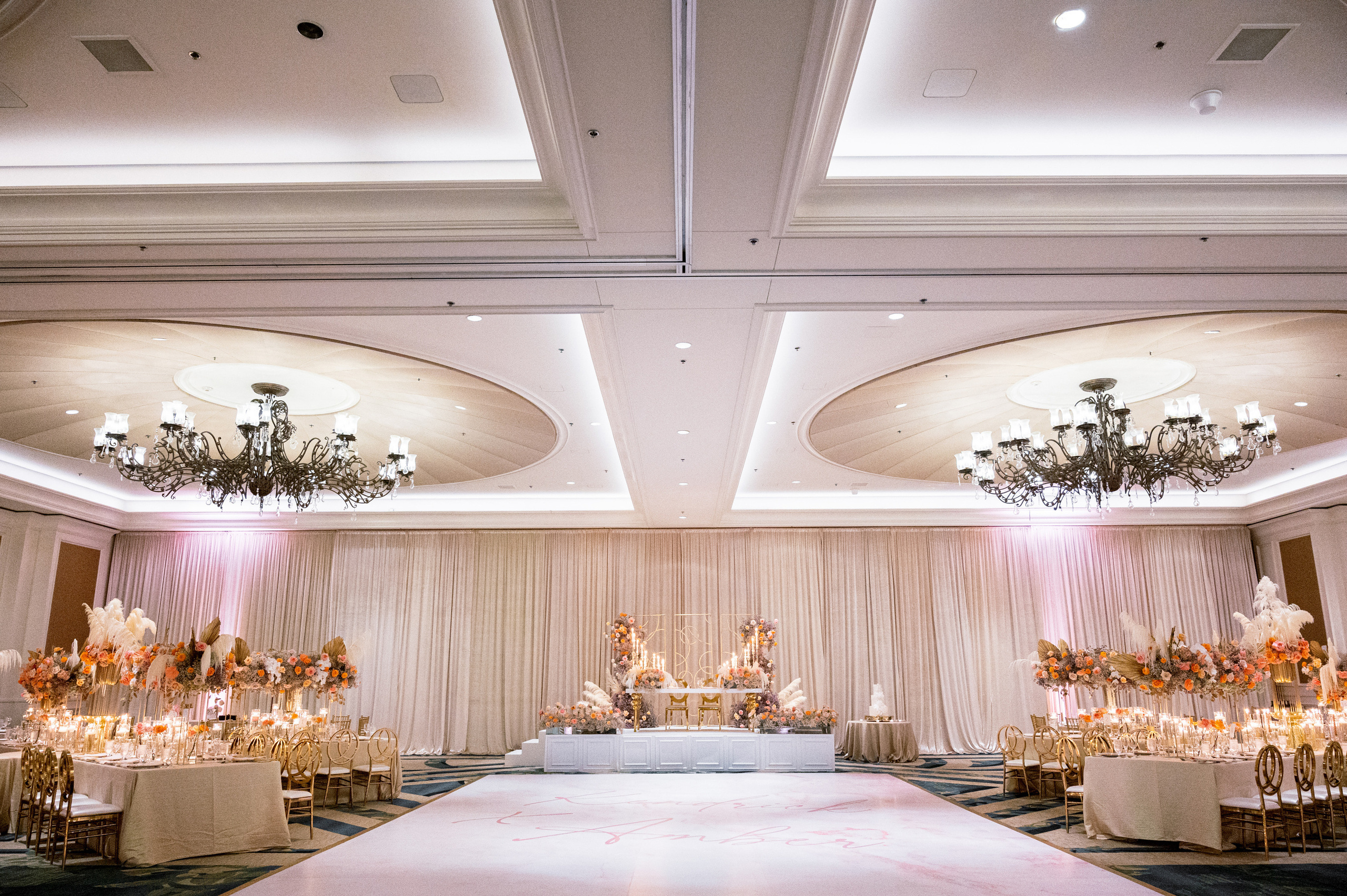 a wedding reception with a large table and a chandel