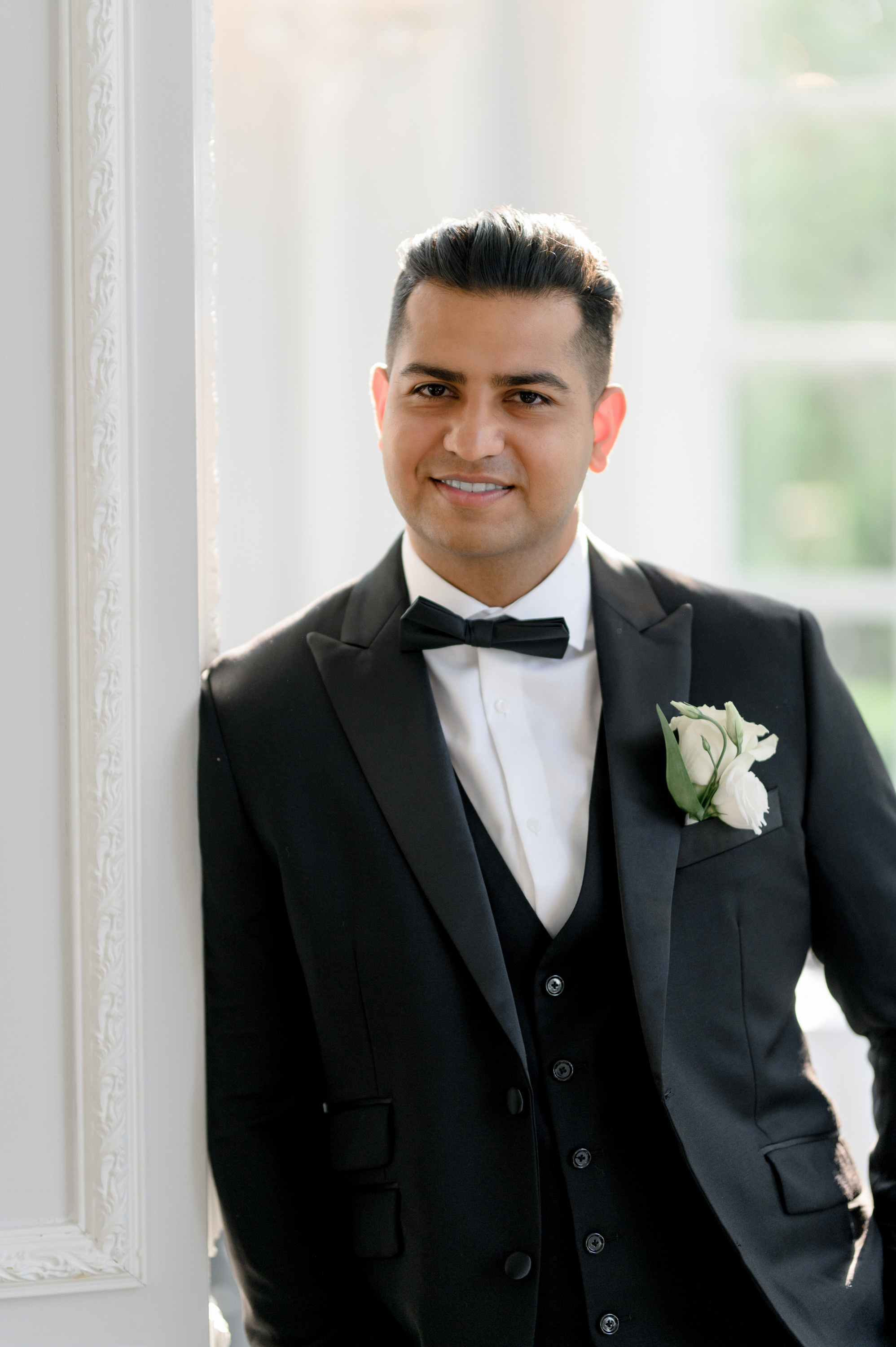 a man in a suit and bow tie