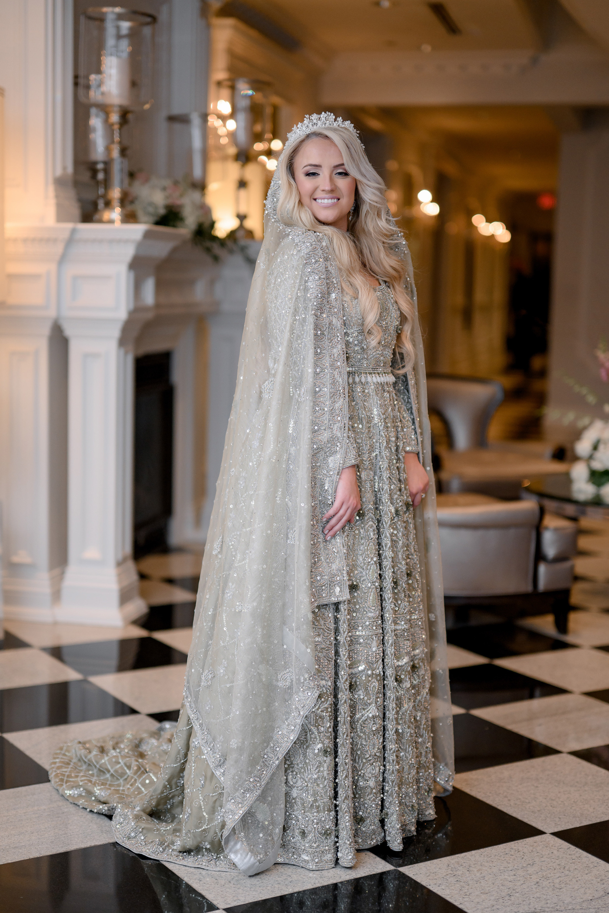 a woman in a wedding dress standing on a checkered floor
