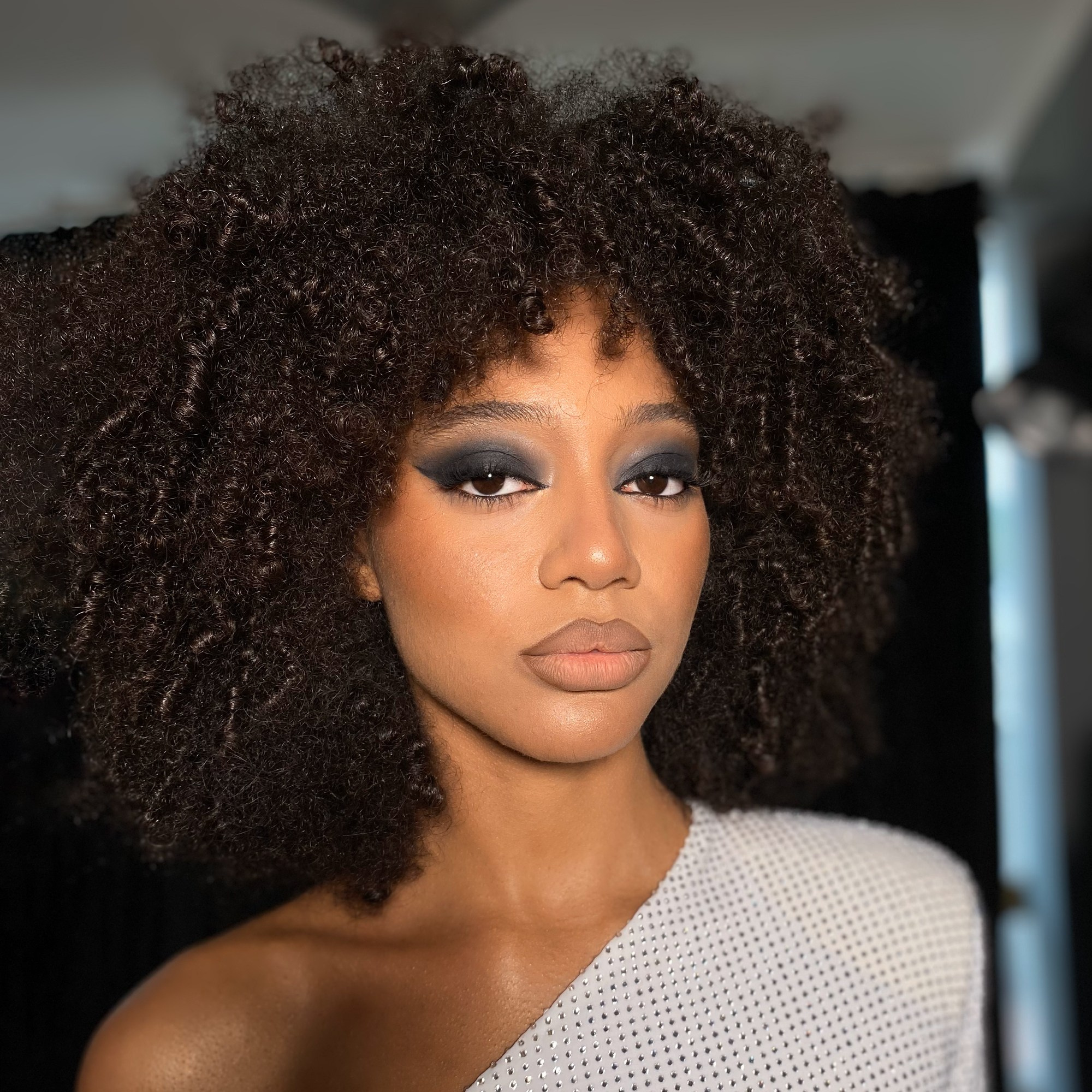 dark skinned girl with a smoky eye and curly hair shooting for Daniele Morena brand in Rome
