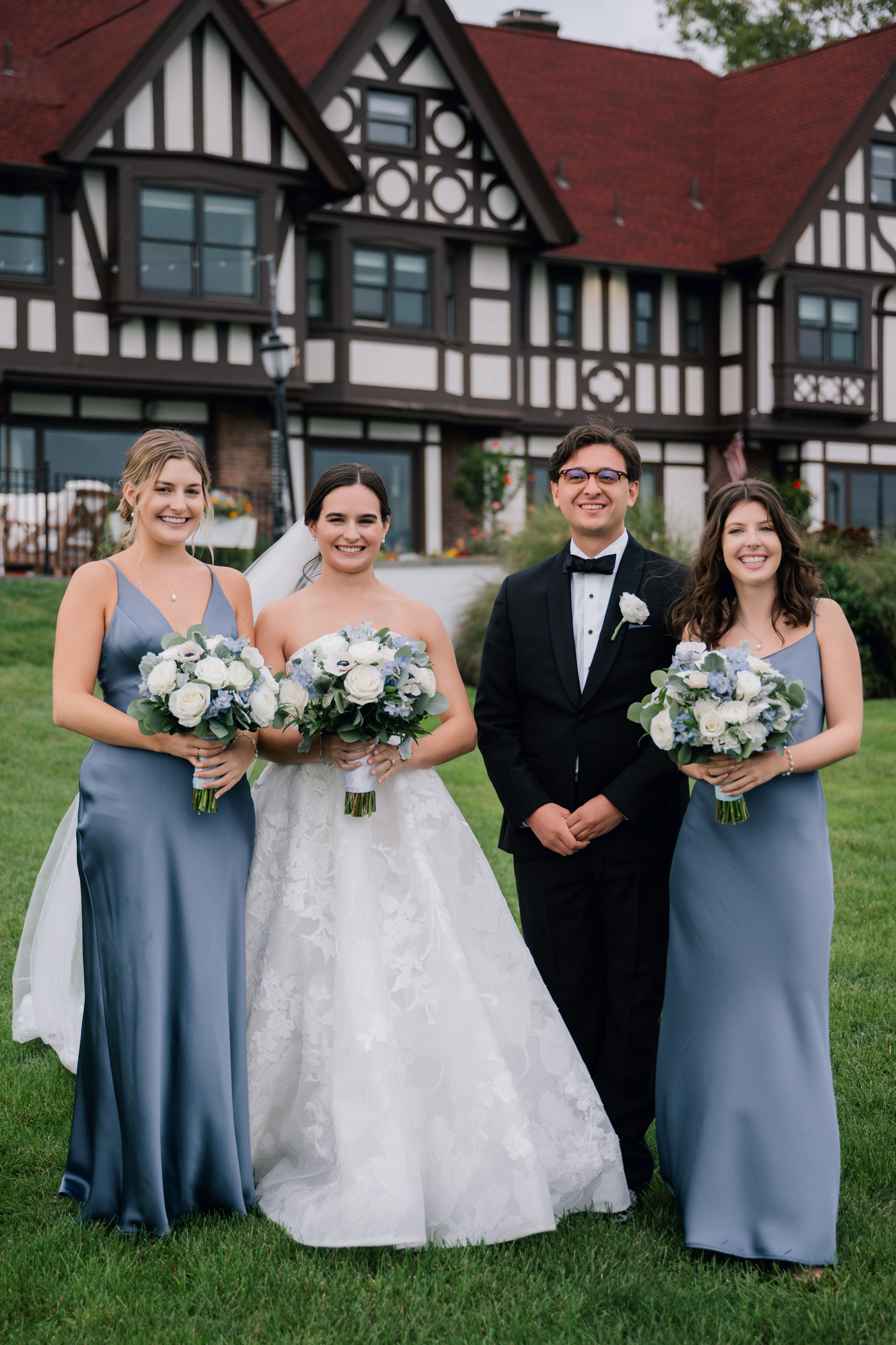 a bride and her bridesmaids pose for a photo in front of the house