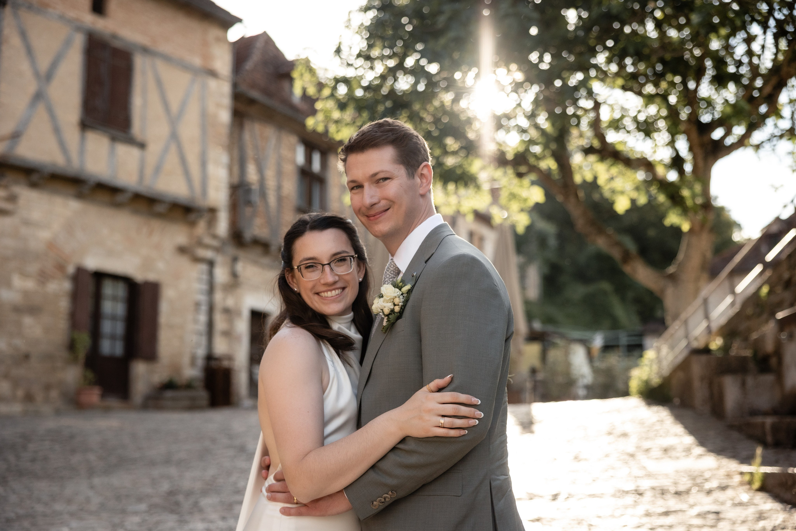 Couple embracing in a medieval stone passage in Saint-Cirq-Lapopie