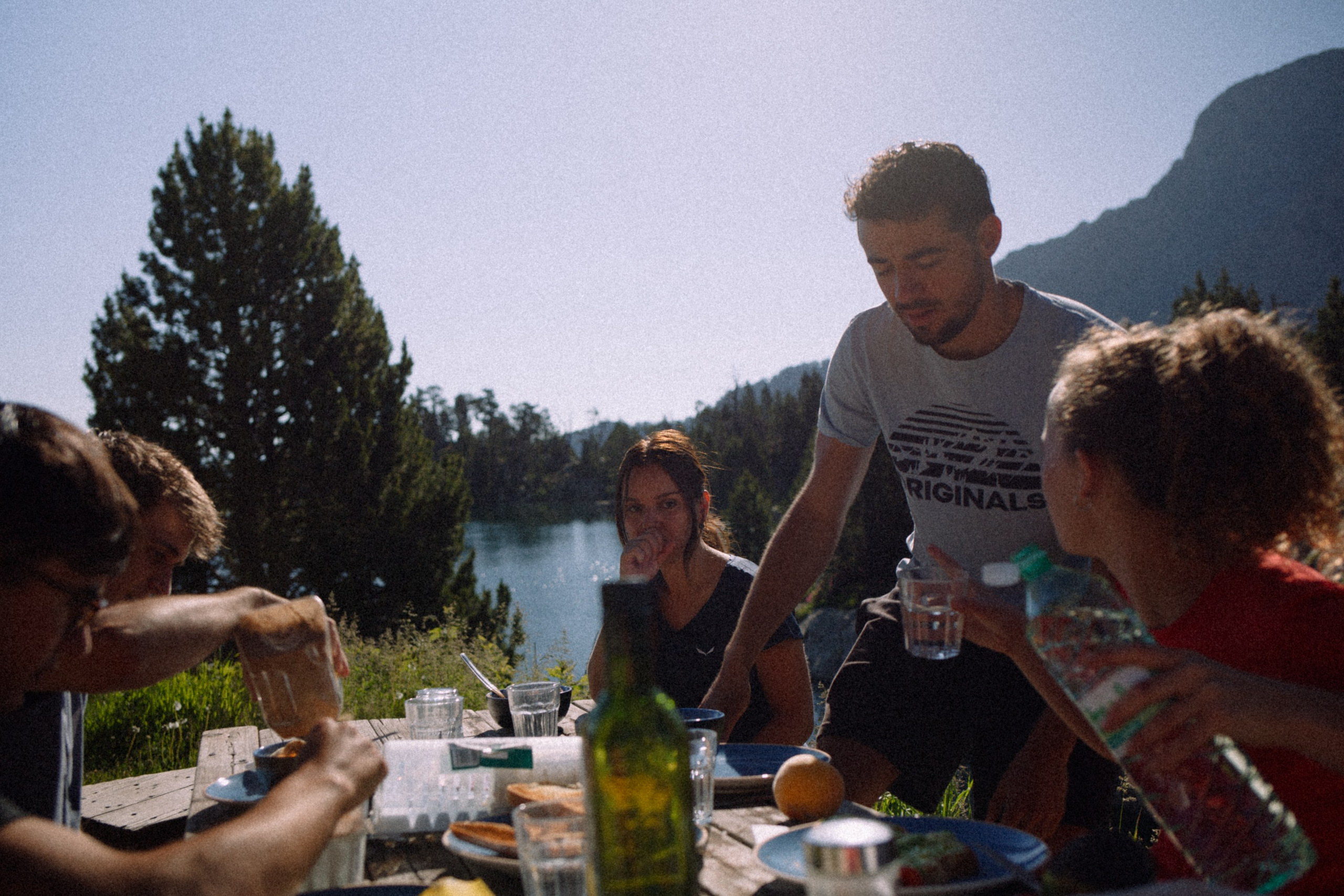 A group of people enjoying a meal together in natur