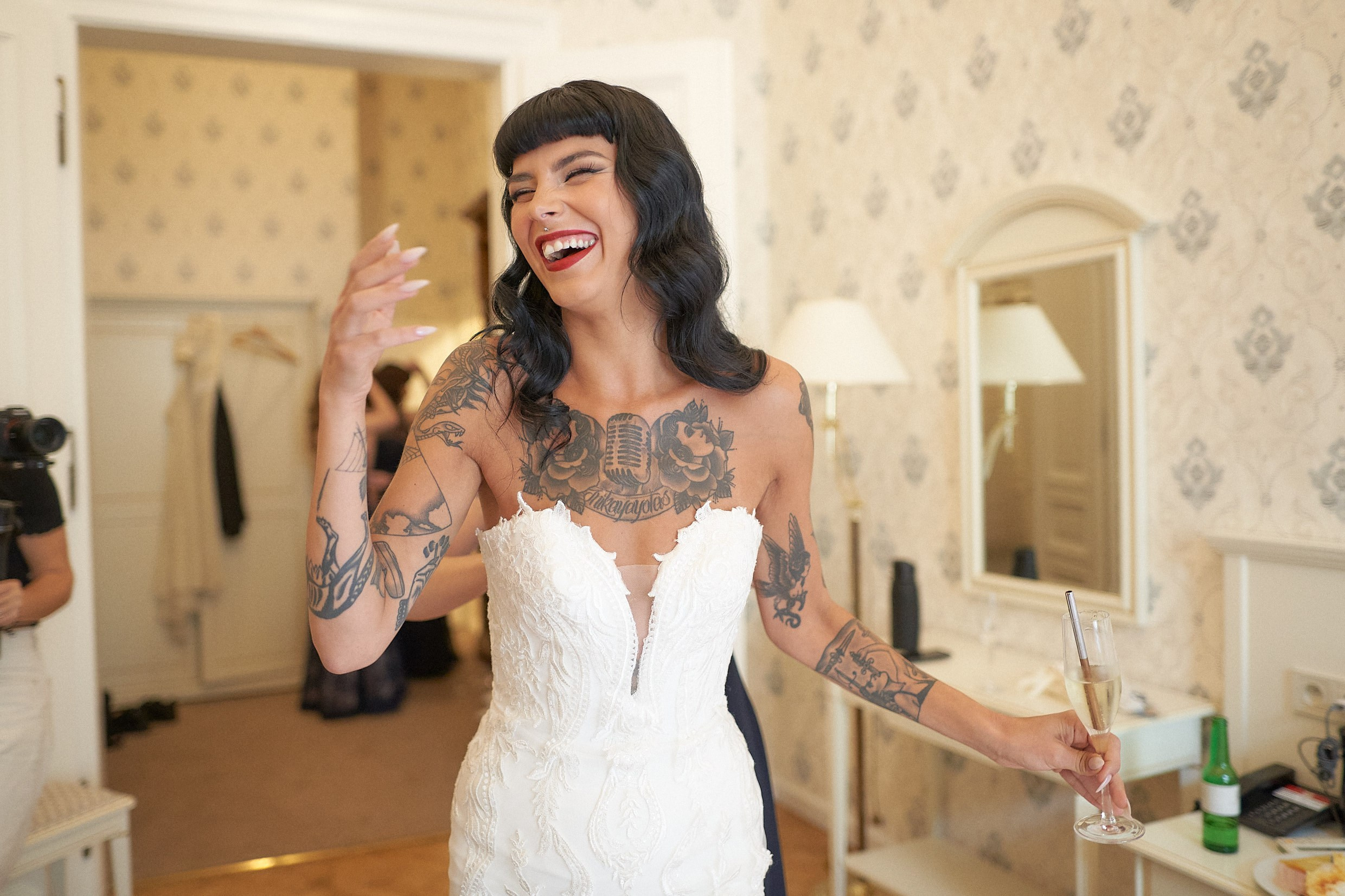 Emotional bride smiling in awe after donning wedding gown.