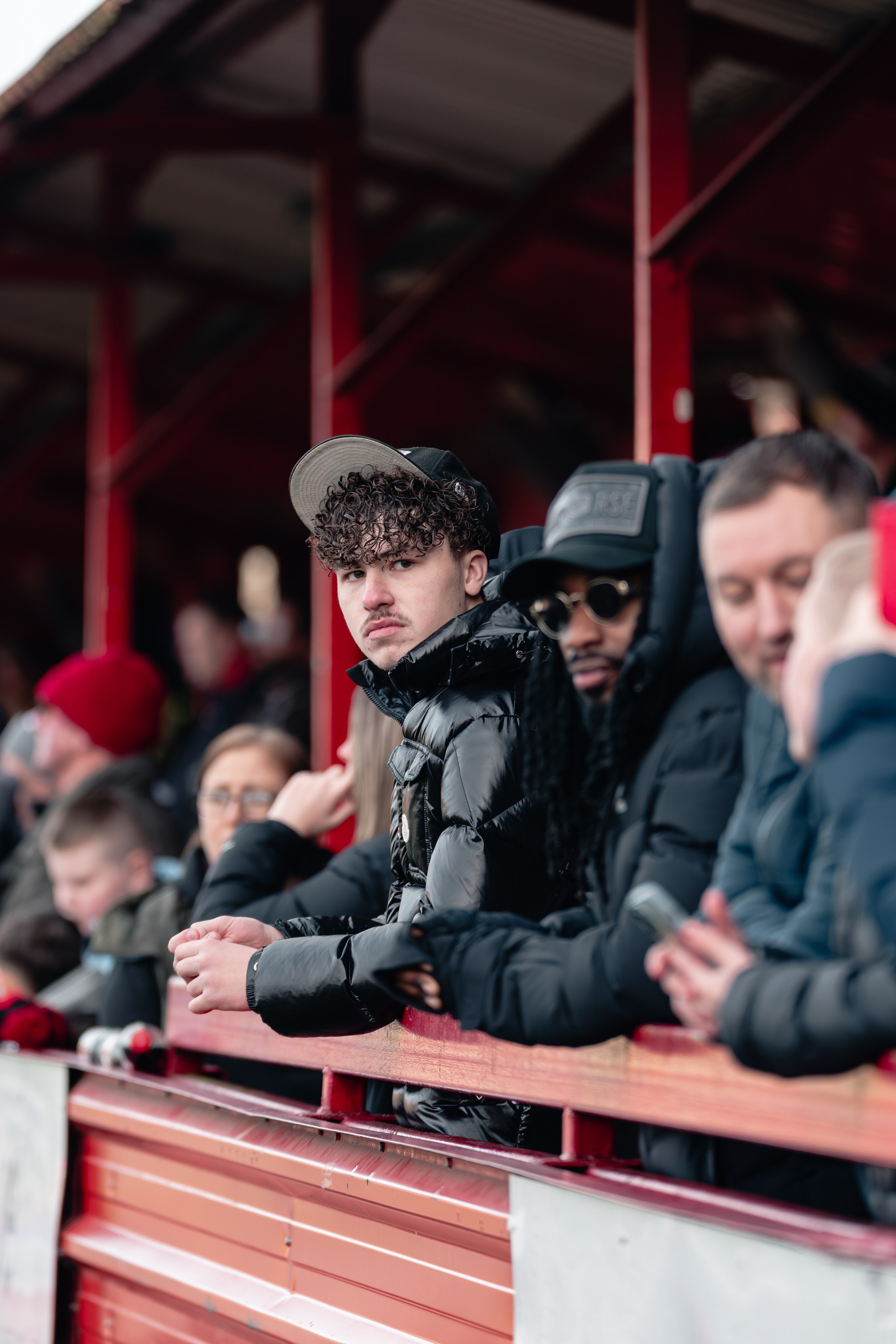 Tamworth, England — February 14, 2026: Tamworth FC supporters watch from the stands during the Enterprise National League match between Tamworth and Aldershot Town at The Lamb Ground. Photo: Jay Soundo