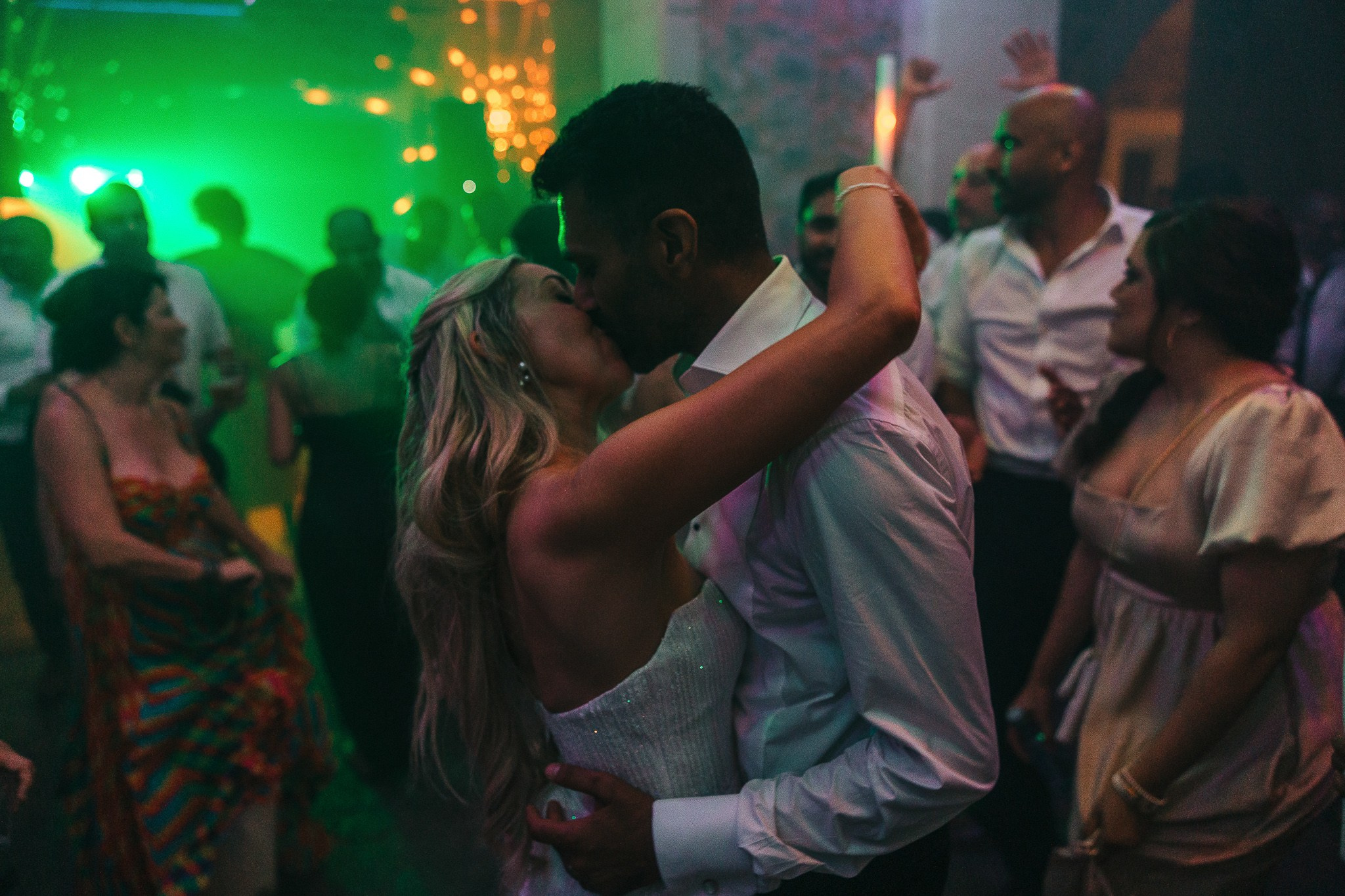Bride and groom sharing a kiss on the dance floor at their Mallorca wedding reception
