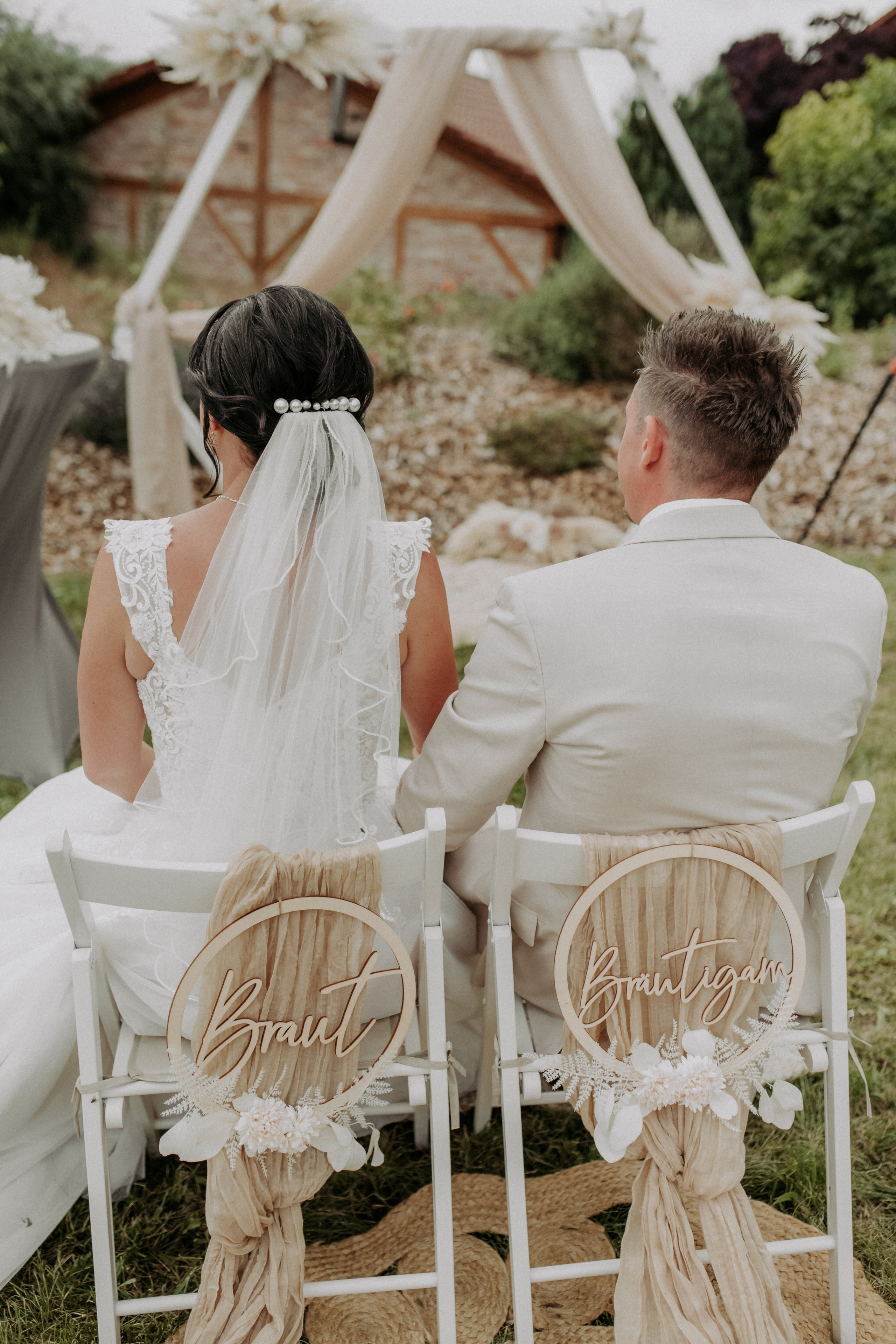Brautpaar spaziert Hand in Hand durch den Garten – Wunderschönes Paarfoto in der Natur am Steinfeld