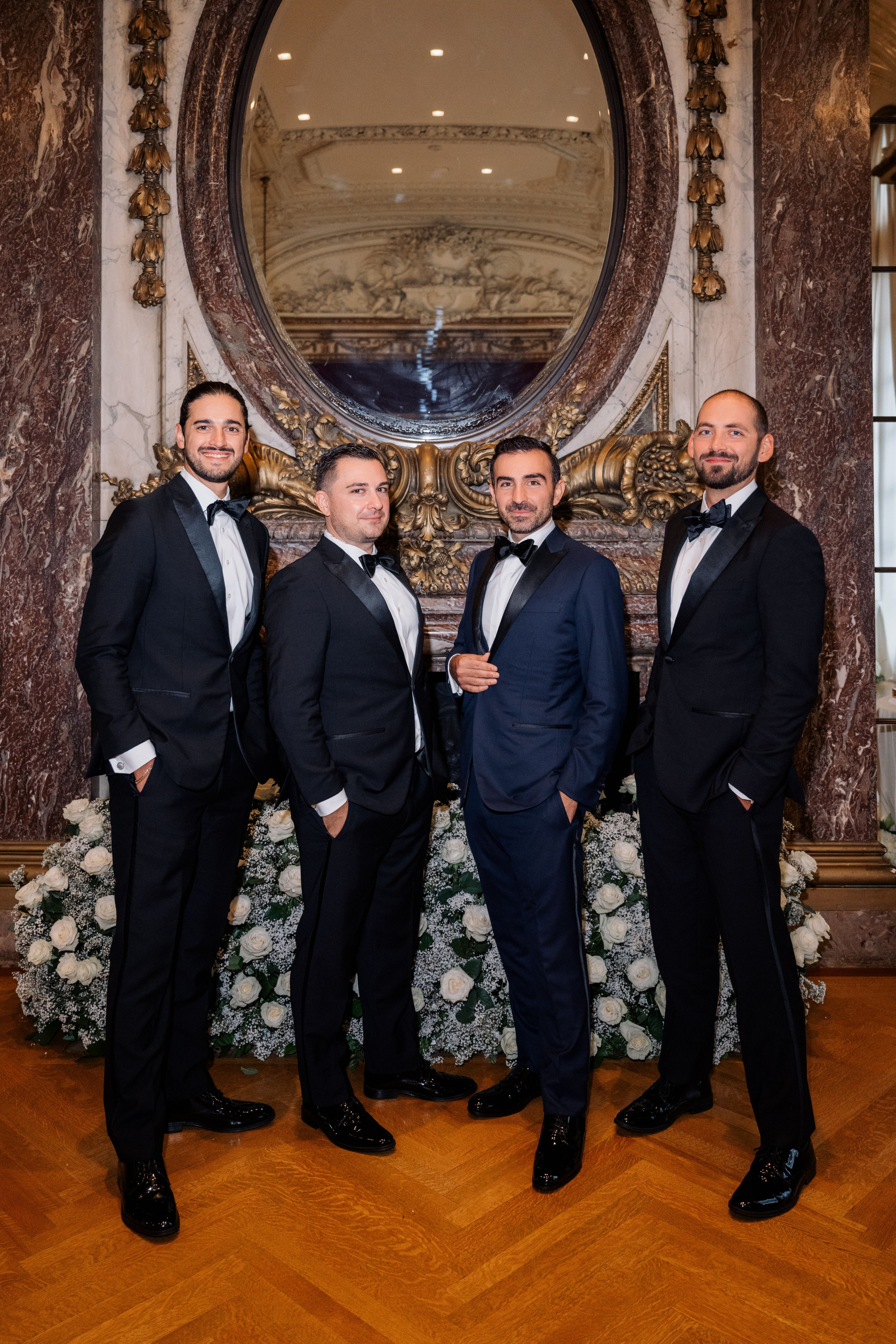 a group of men in tuxed suits posing for a picture