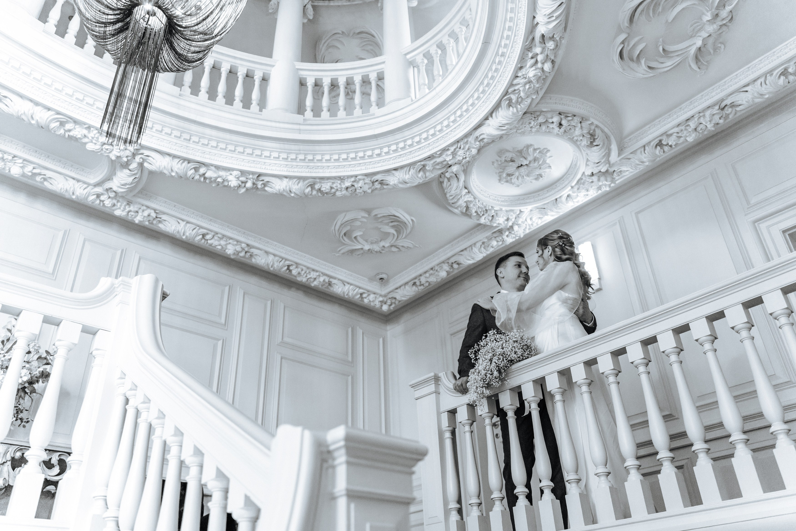 Wedding portraits of Andrey and Elena on the grand staircase at Barnet Hill Hotel in an elegant historic setting.