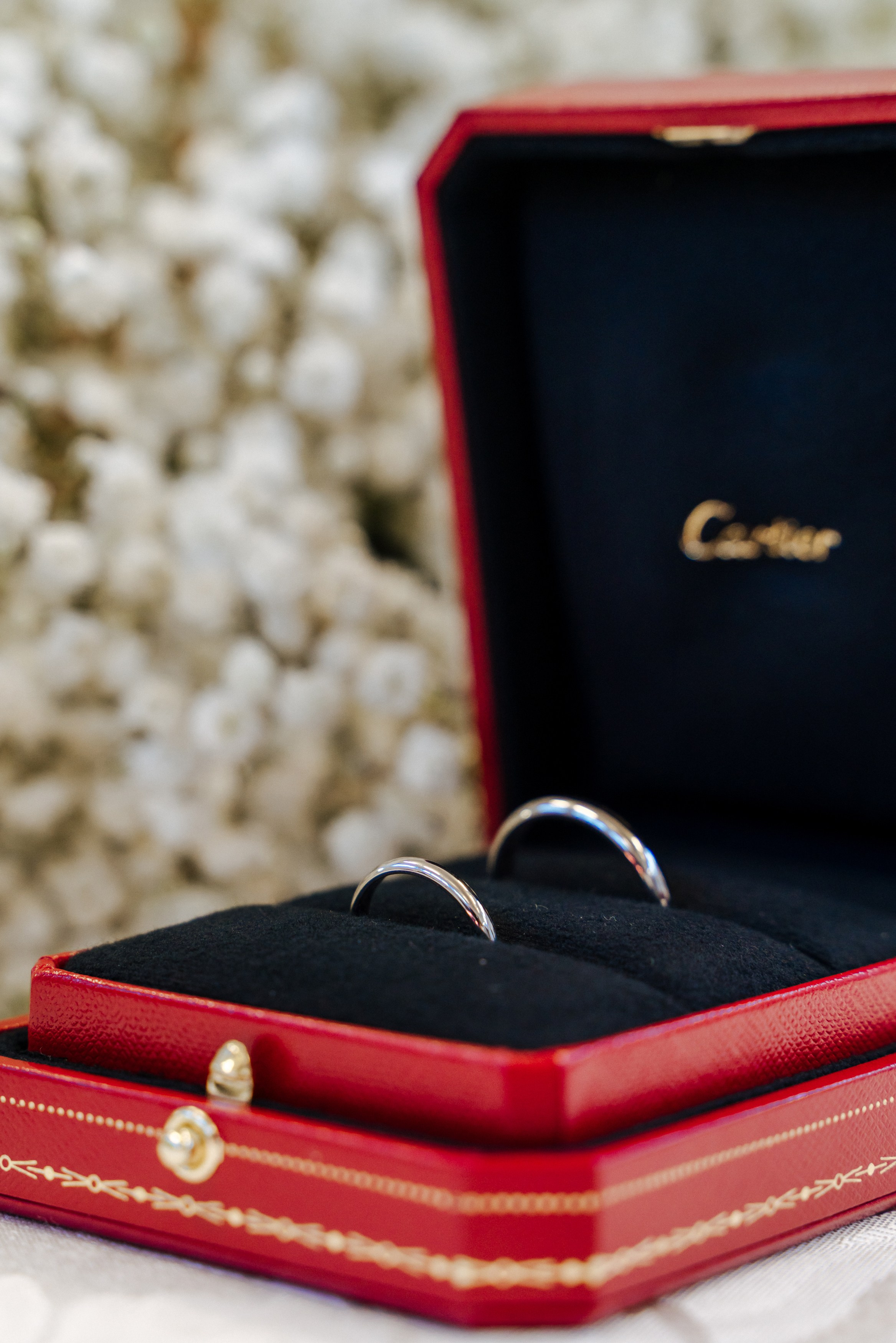 Close-up of the wedding rings in a red jewellery box, photographed before Andrey and Elena's wedding ceremony.