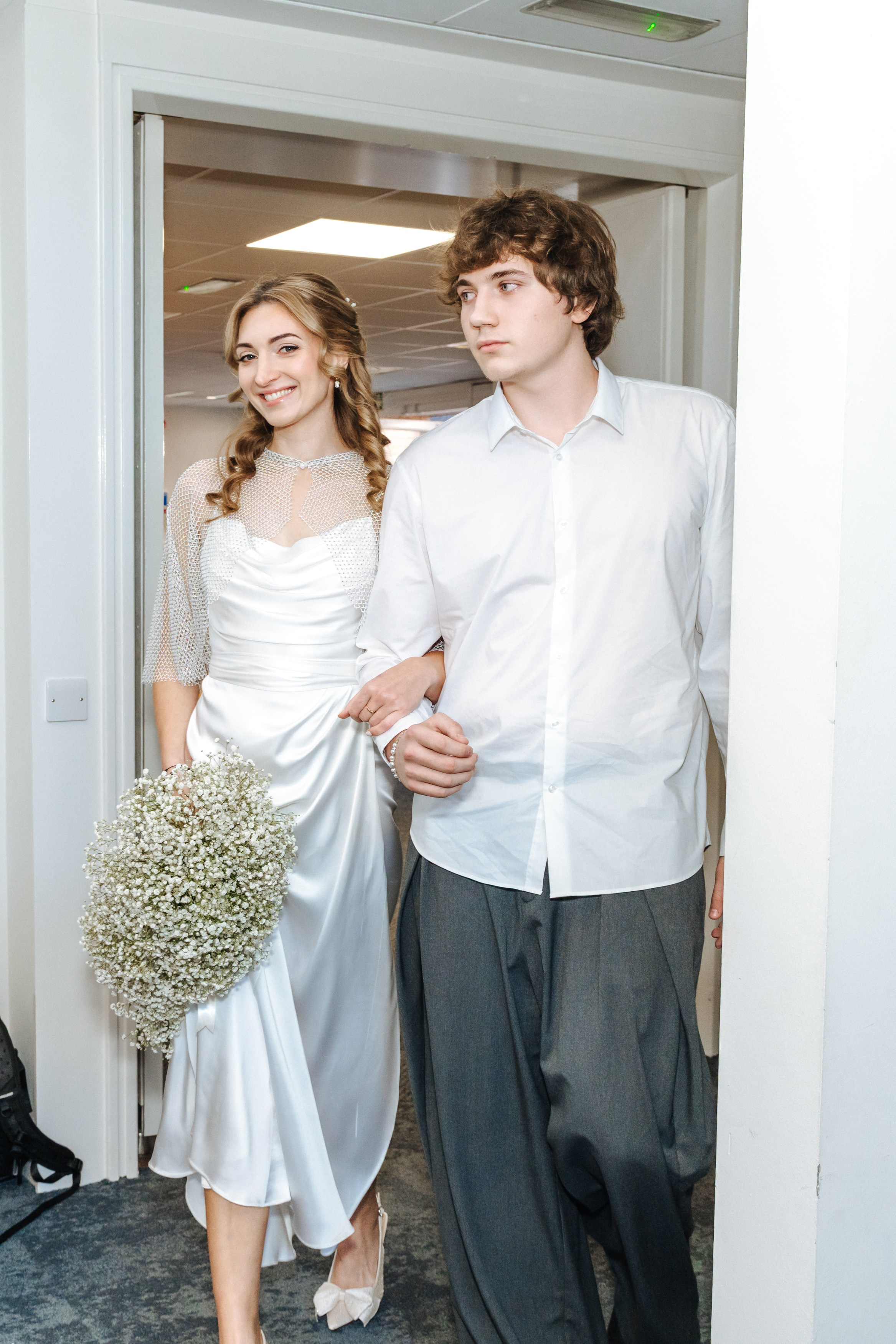 Andrey and Elena enter their civil wedding ceremony at Midsomer Court, surrounded by family and friends.