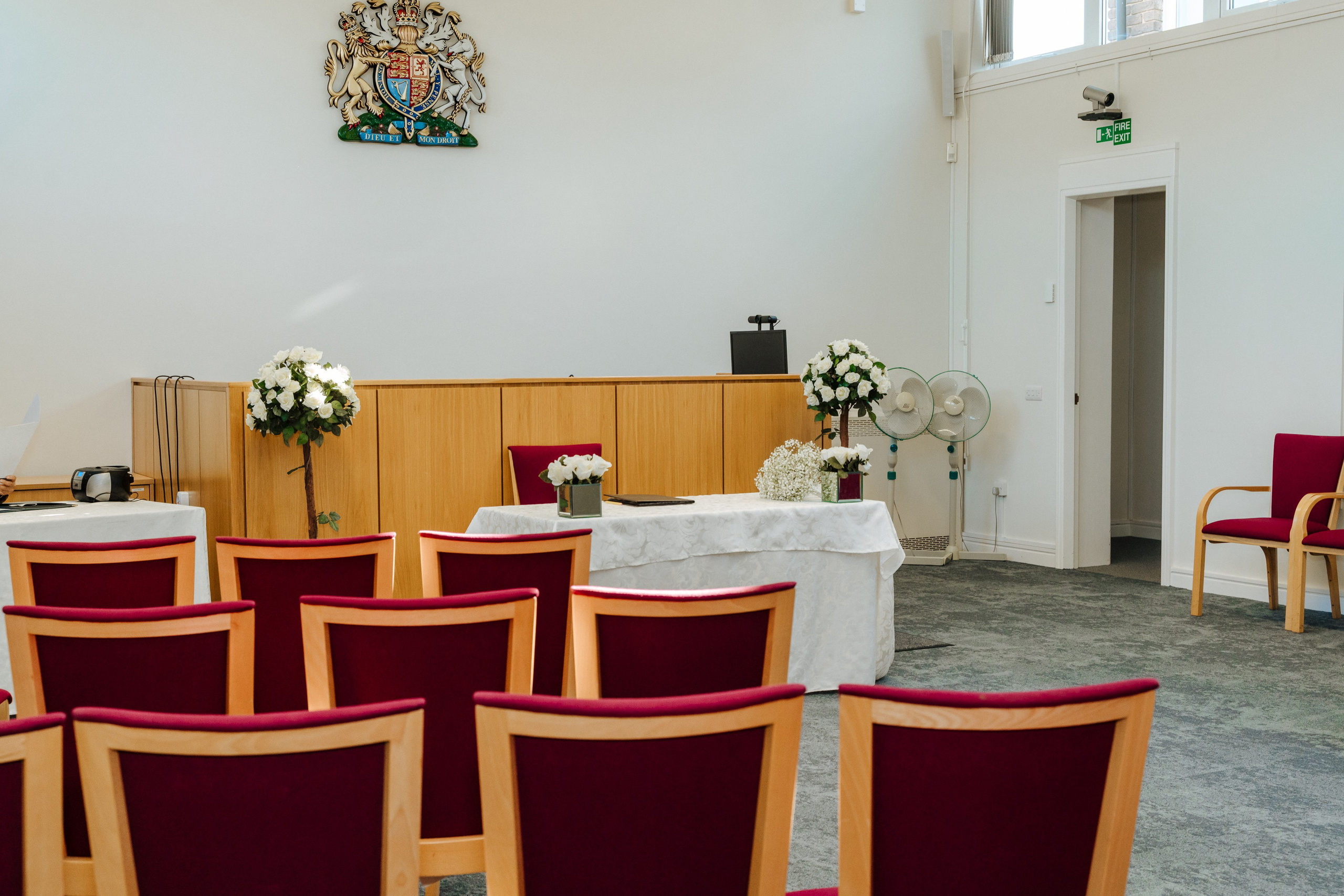 Intimate civil wedding ceremony room at Midsomer Court in Beaconsfield, decorated with flowers and arranged for the couple's special day.