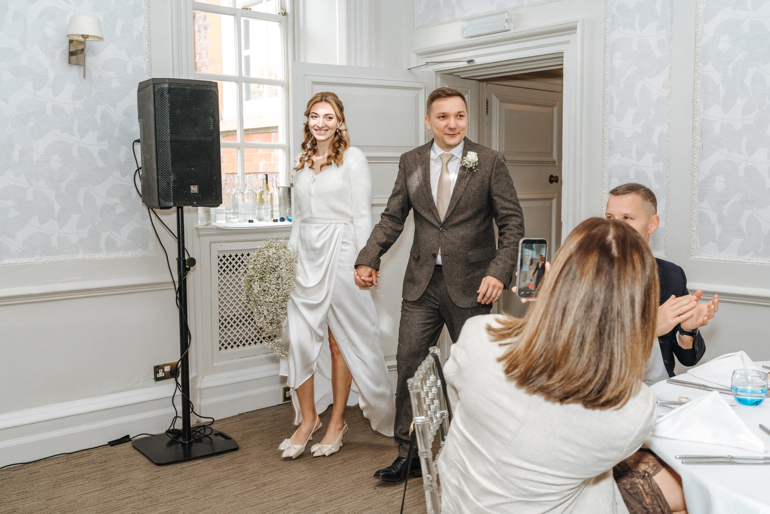 Andrey and Elena arrive at their wedding reception at Barnet Hill Hotel as their family and friends welcome them.