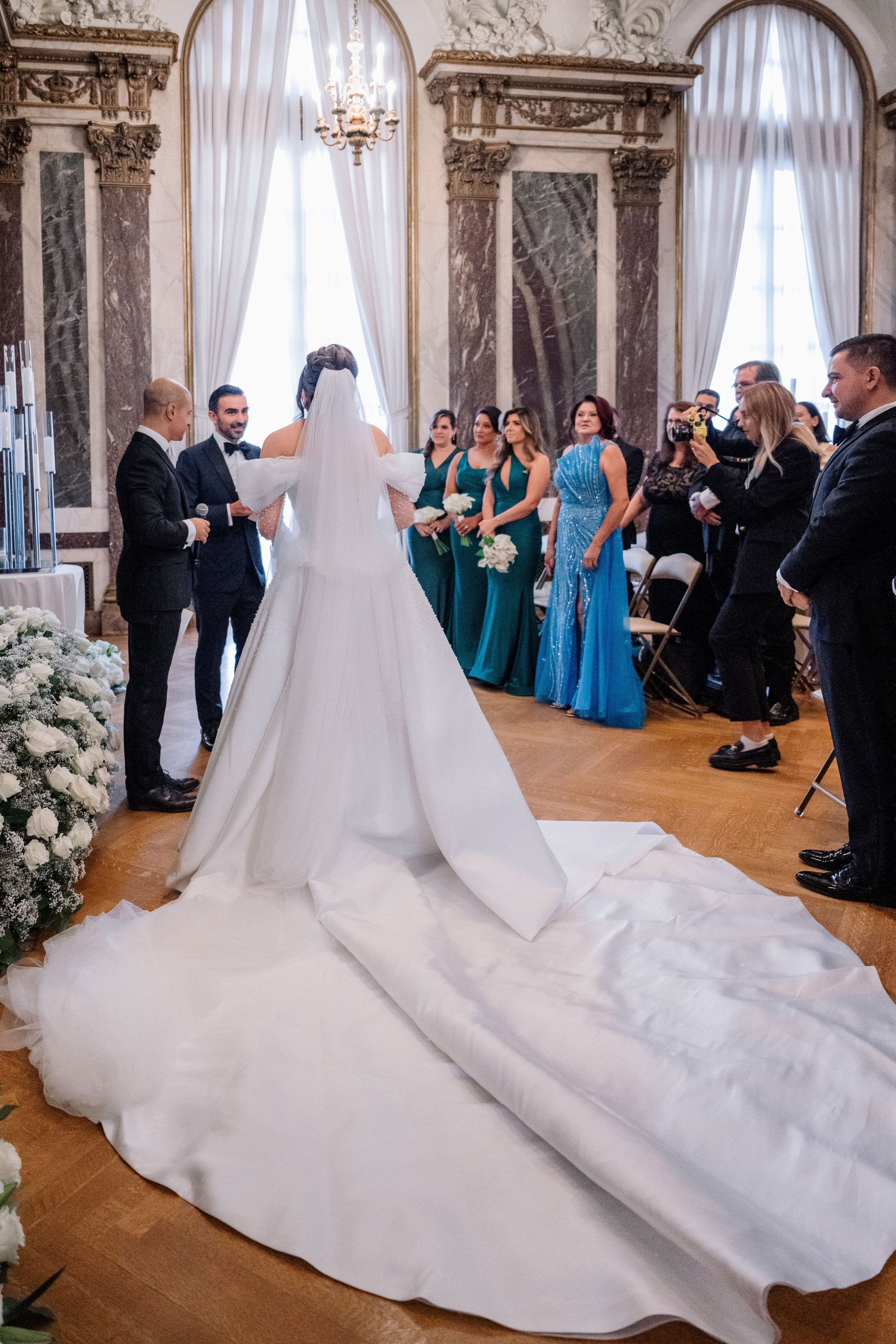 a bride and groom are standing in front of a wedding ceremony