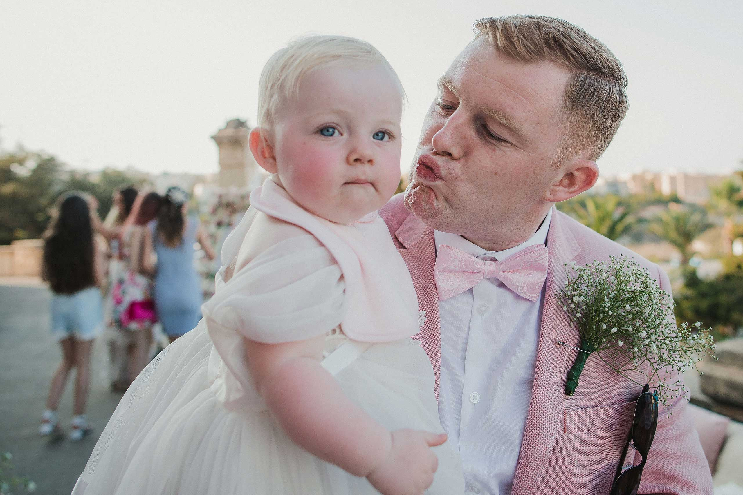 Gentleman kissing baby girl