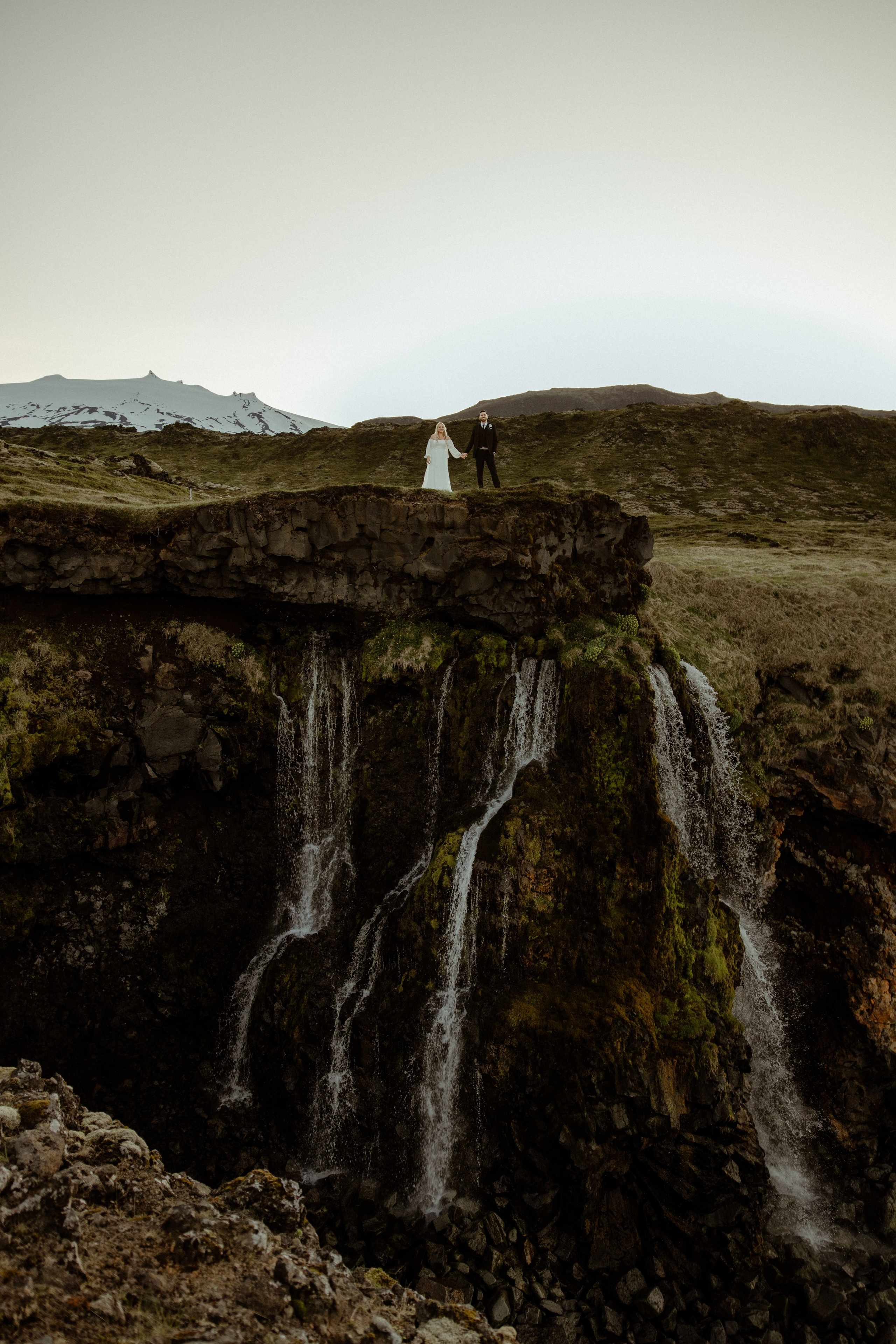 Iceland elopement at Budir with midnight sun wedding photos at black sand beach. Iceland elopement photographer & videographer