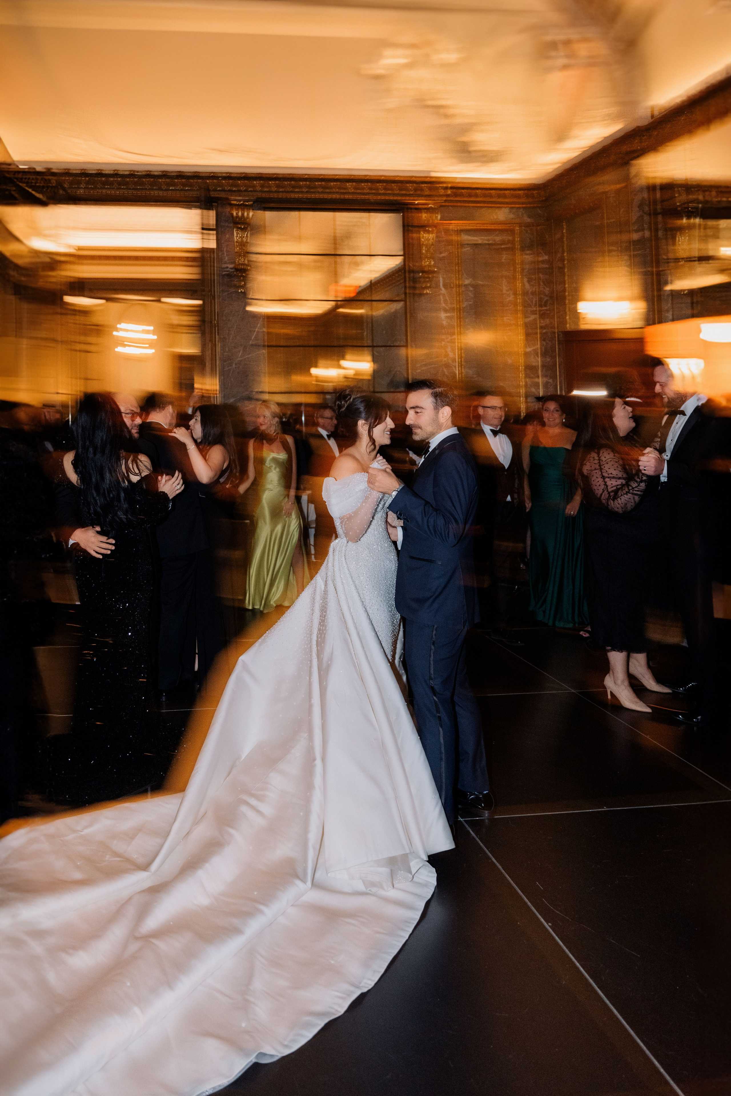 a bride and groom dancing in a ballroom