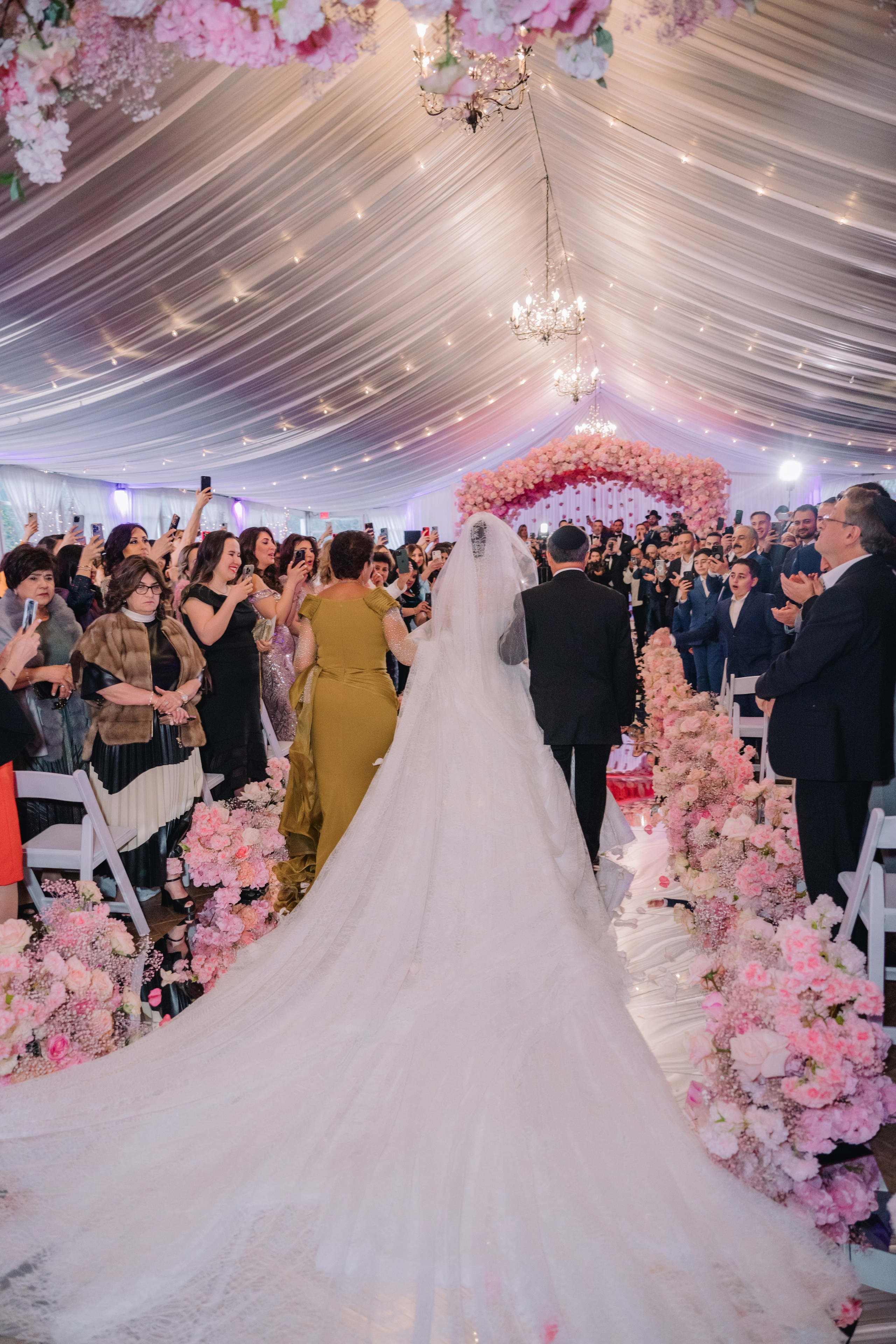 a bride and groom walking down the aisle