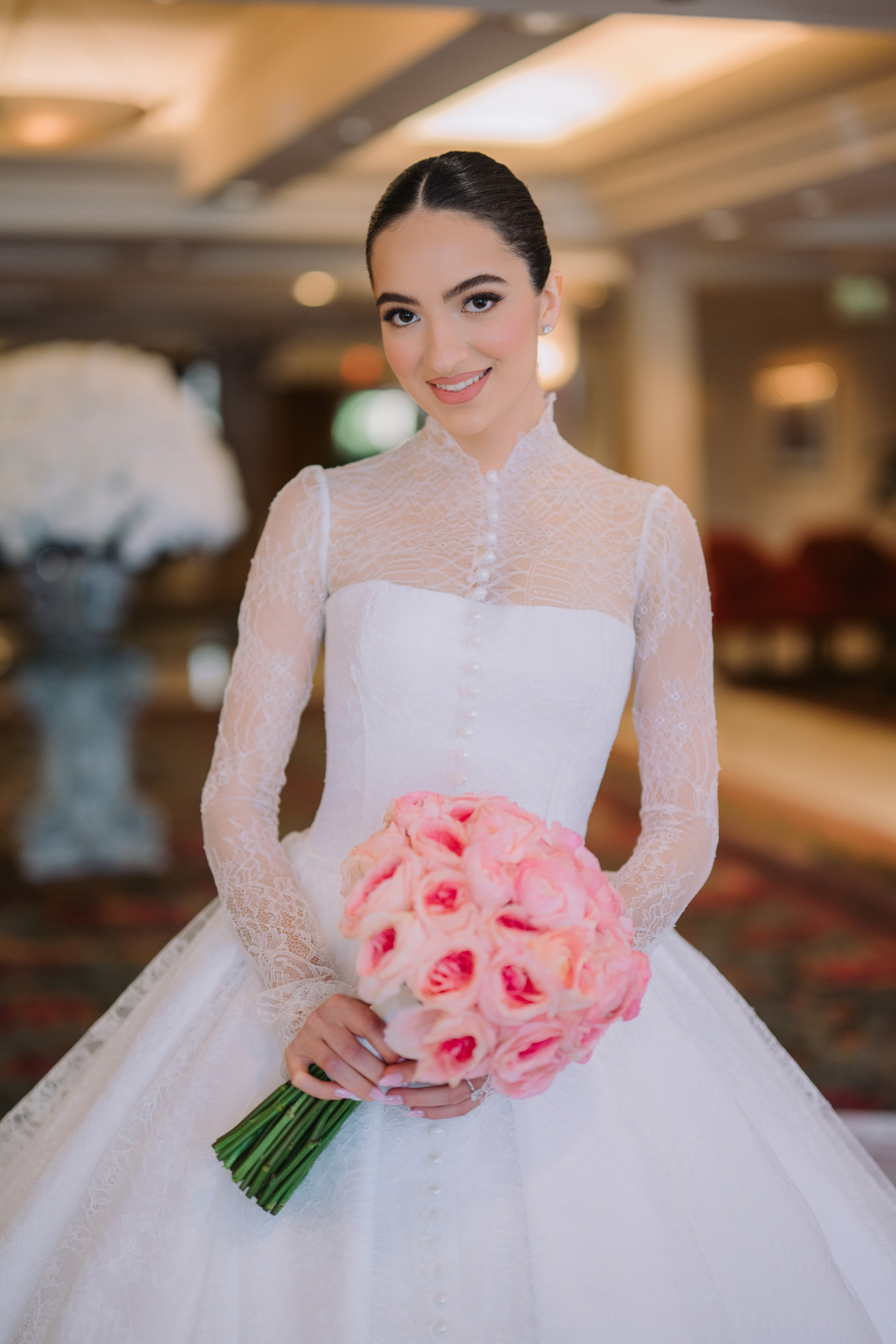 a bride holding her bouquet in the lobby