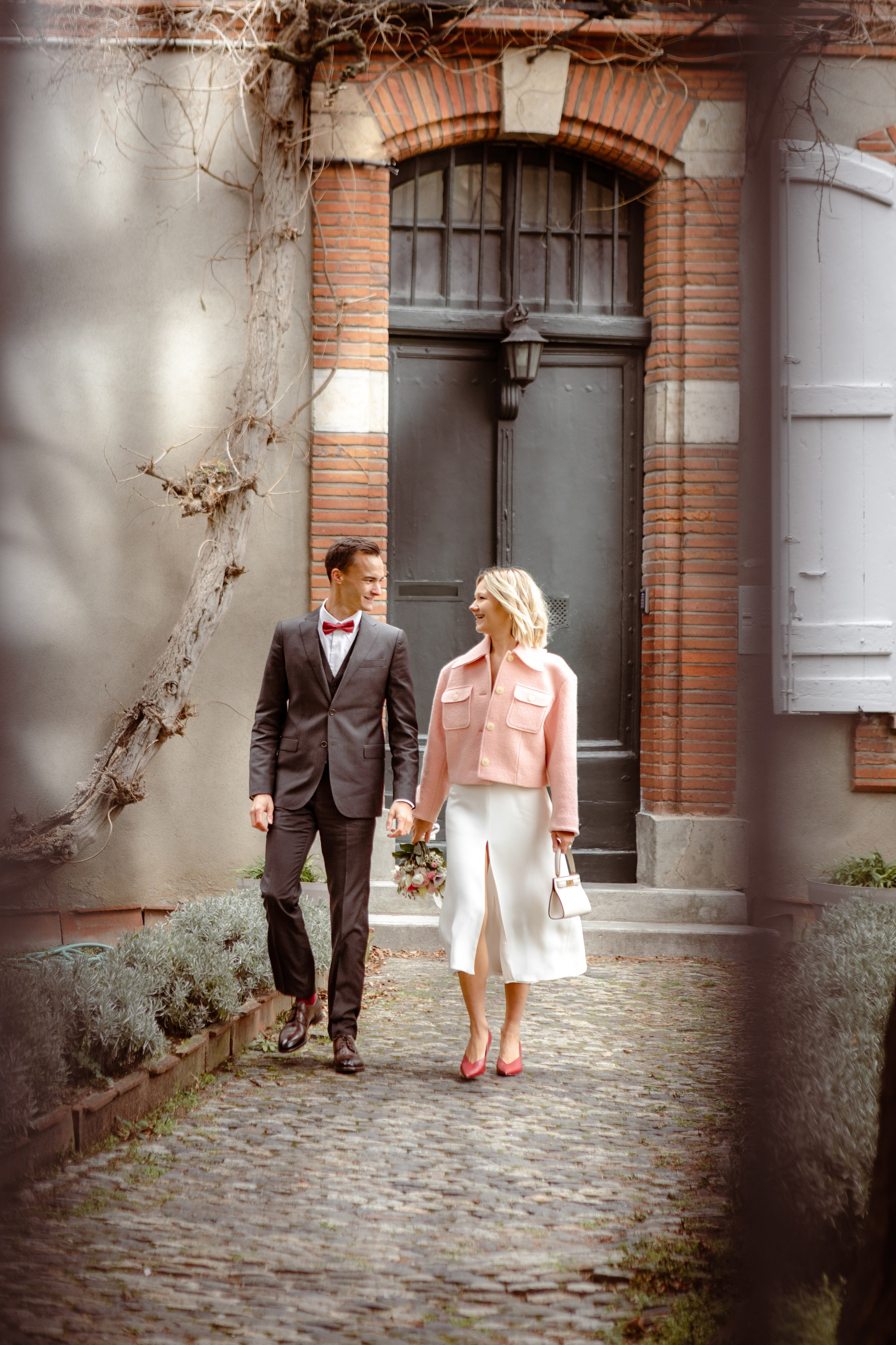Couple of the newlyweds walking on the streets of Toulouse