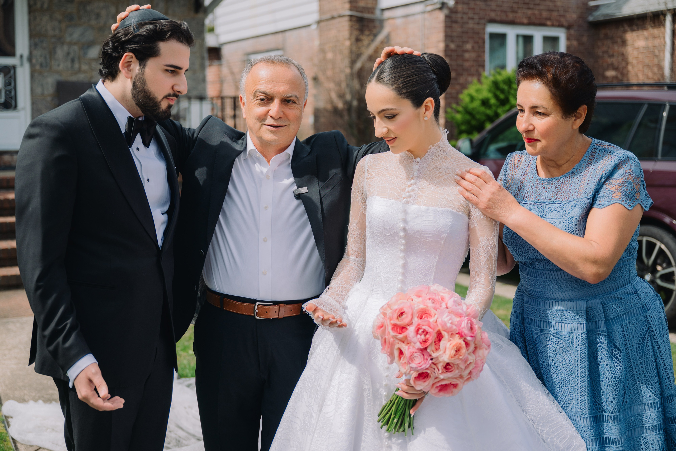 a bride and groom are standing next to a woman