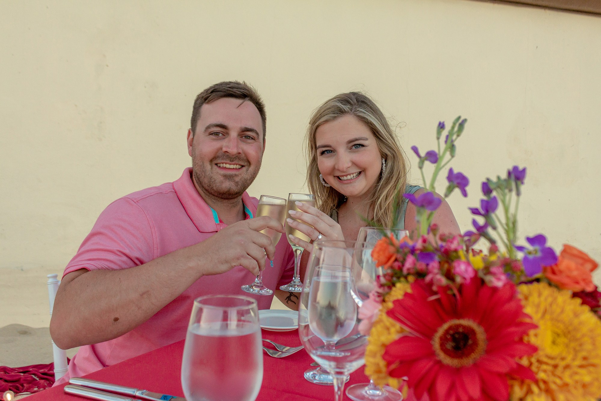 Couple celebrating engagement with romantic beach dinner in Los Cabos Mexico