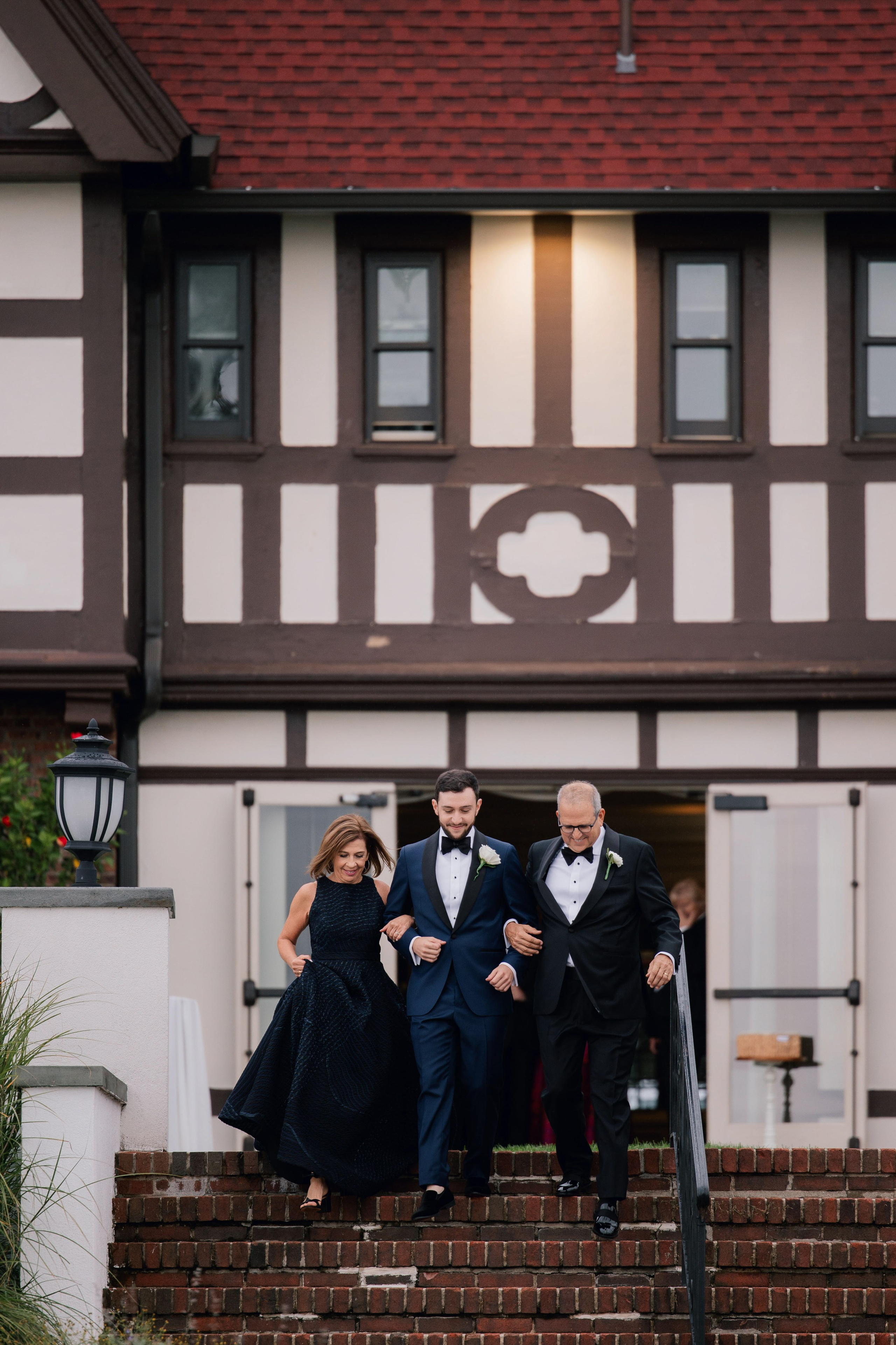 a couple walking up the stairs of a house