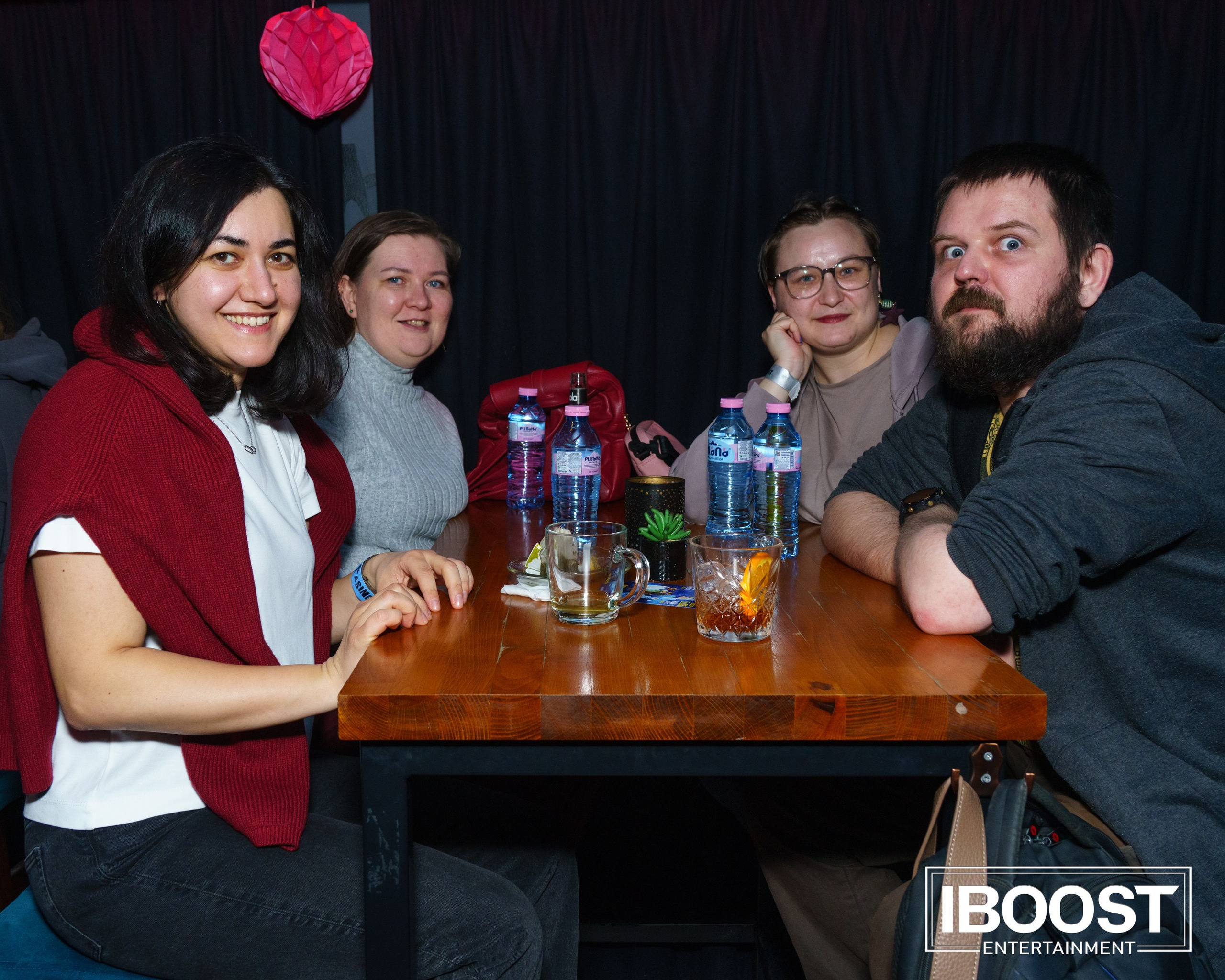 Three guests sitting at a table with drinks during the Animal JazZ concert in Sofia.