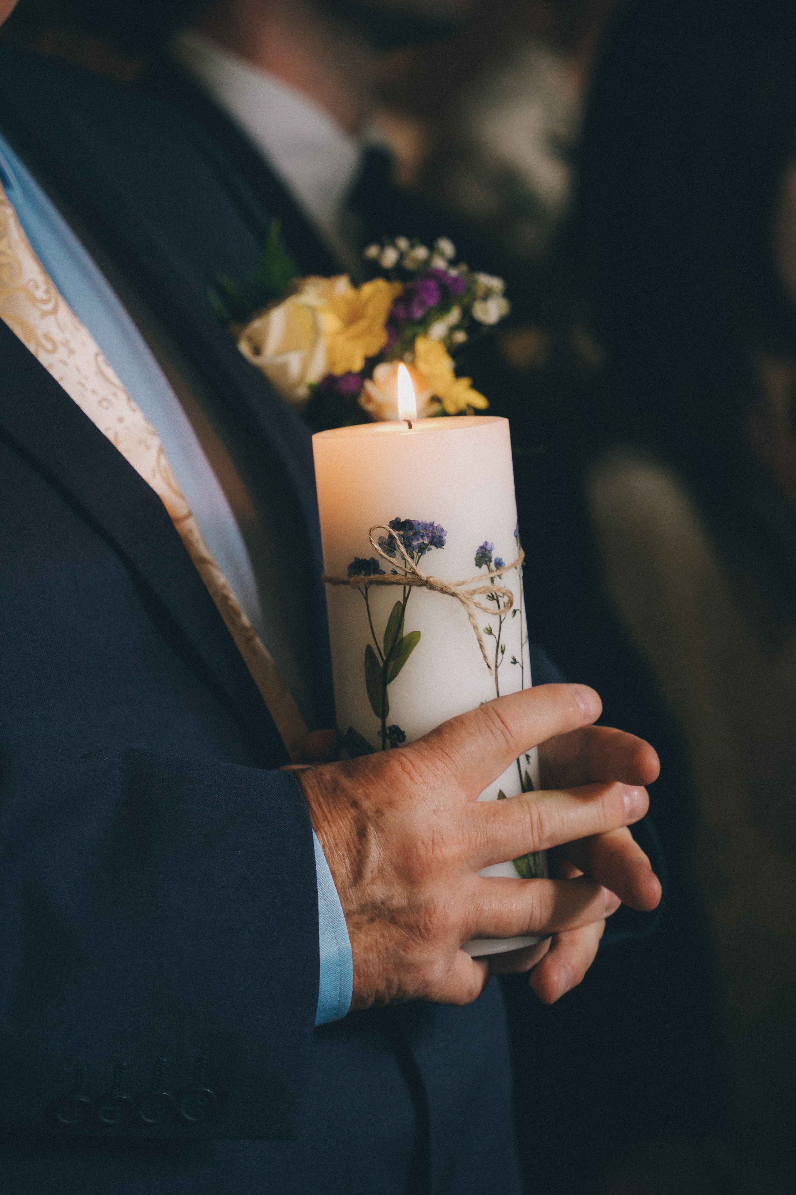holding candle in chapel at wedding ceremony