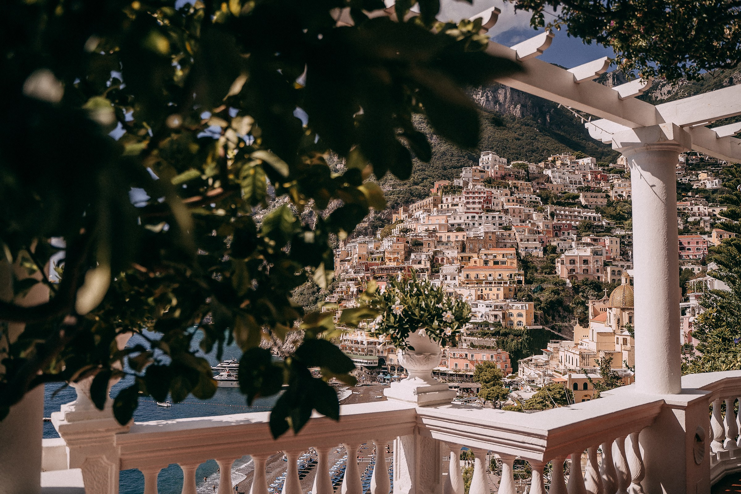 A picturesque view of Positano from Villa Bohème, showcasing vibrant Mediterranean homes cascading down the hillside to the beach.