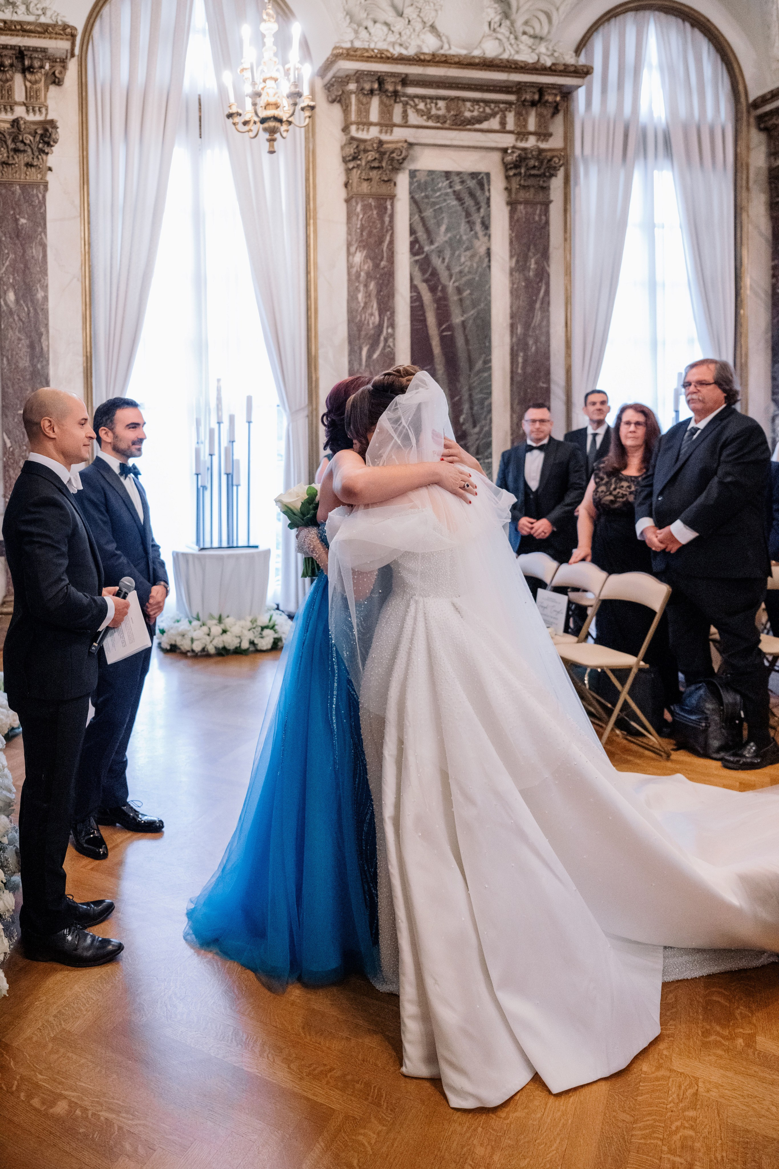 a bride and groom hug during their wedding ceremony