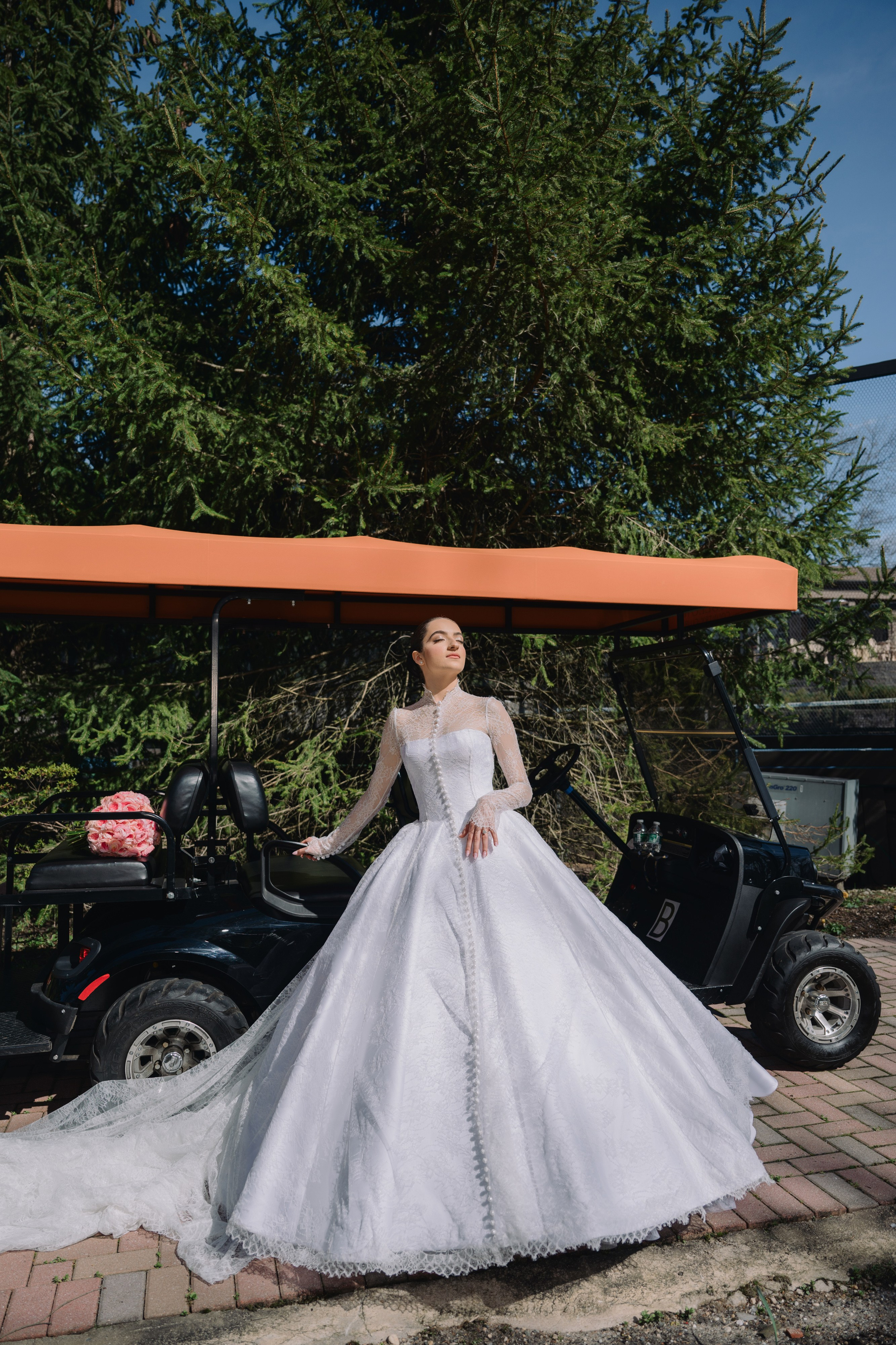 a woman in a wedding dress standing next to a car