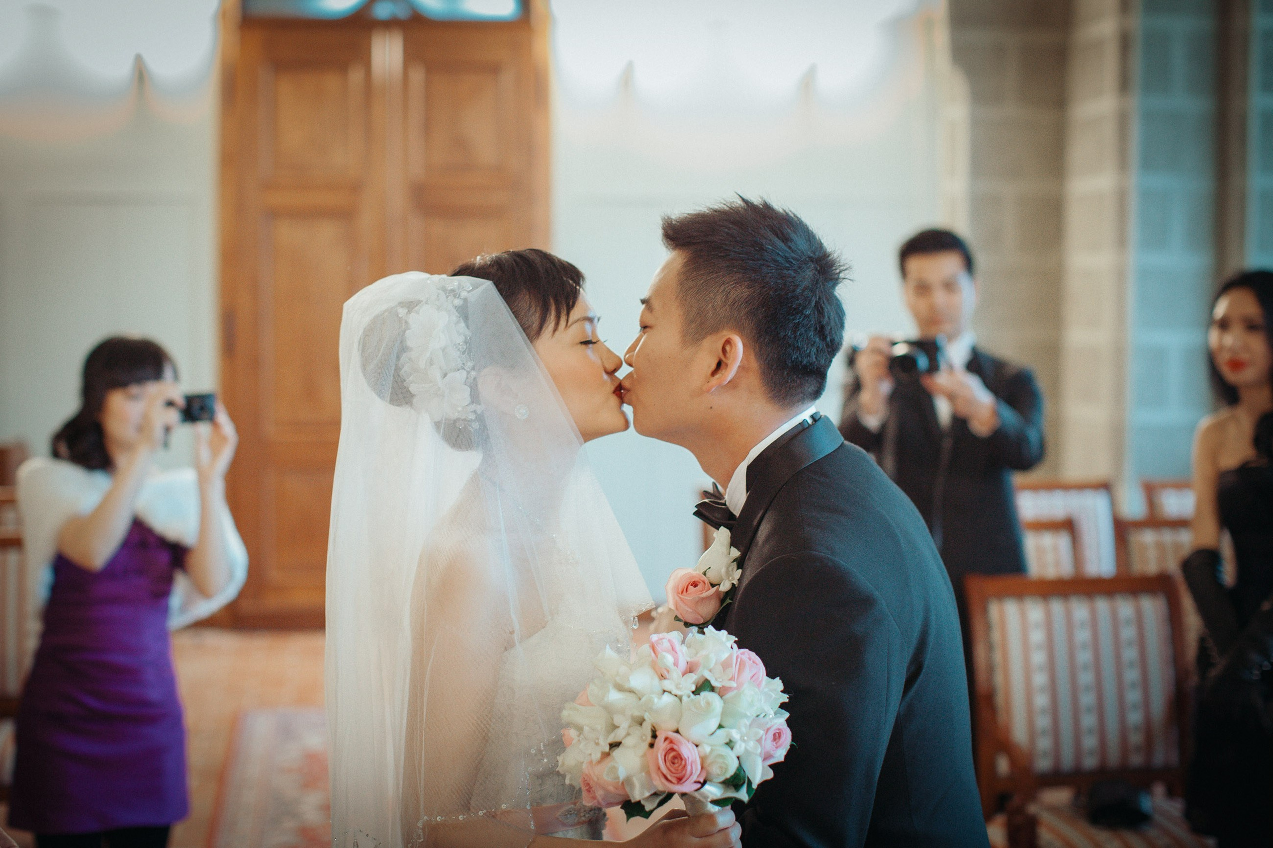 The first kiss of the Hong Kong newlyweds during their romantic candlelit wedding ceremony at the State Chateau of Hluboka in the Czech Republic.