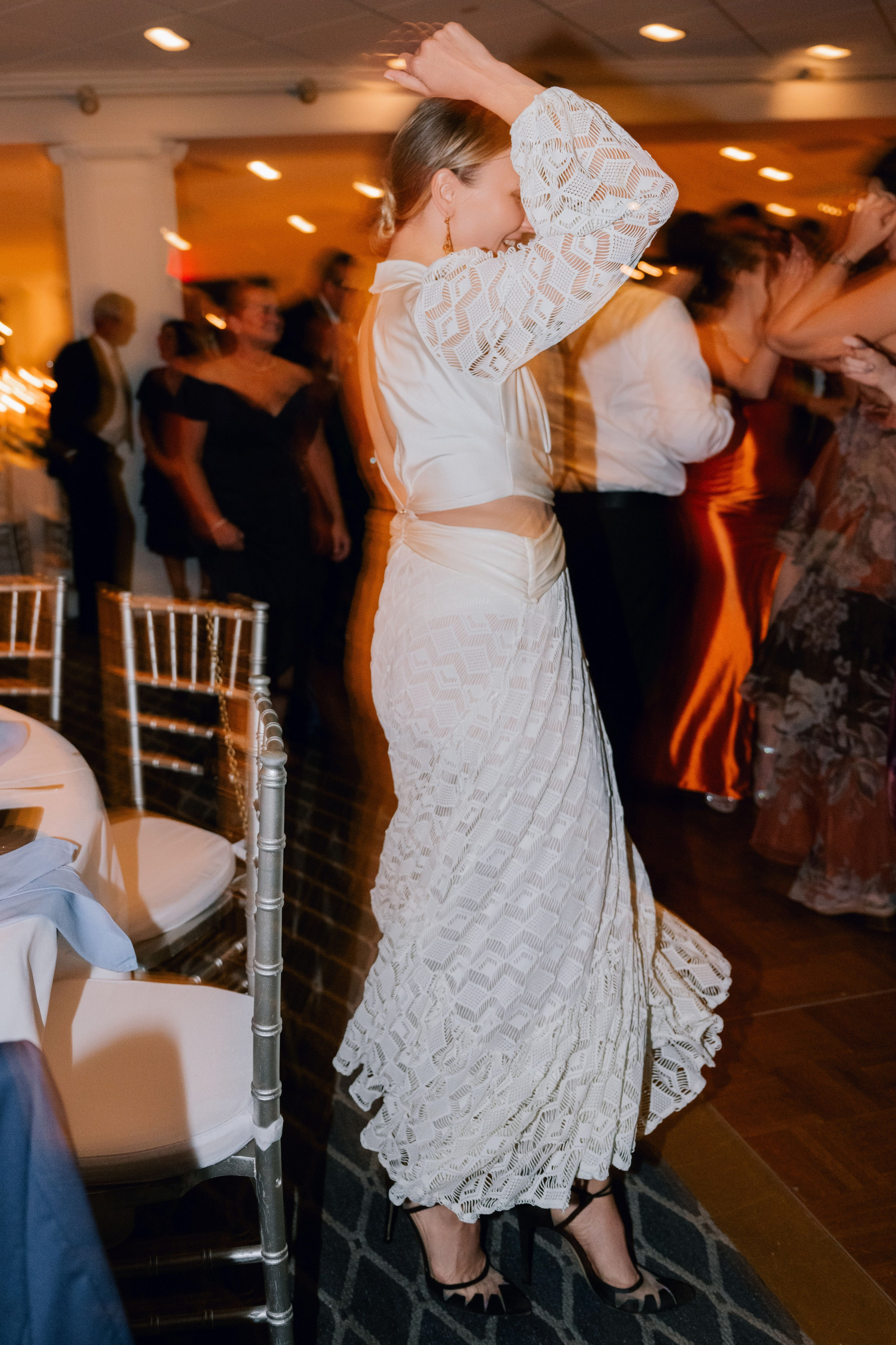 a woman in a white dress dancing on a dance floor