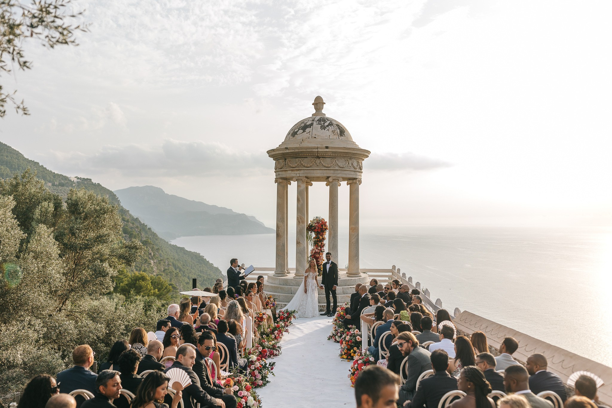Bride and groom exchanging vows with their Son Marroig wedding officiant overlooking the Mallorca coastline
