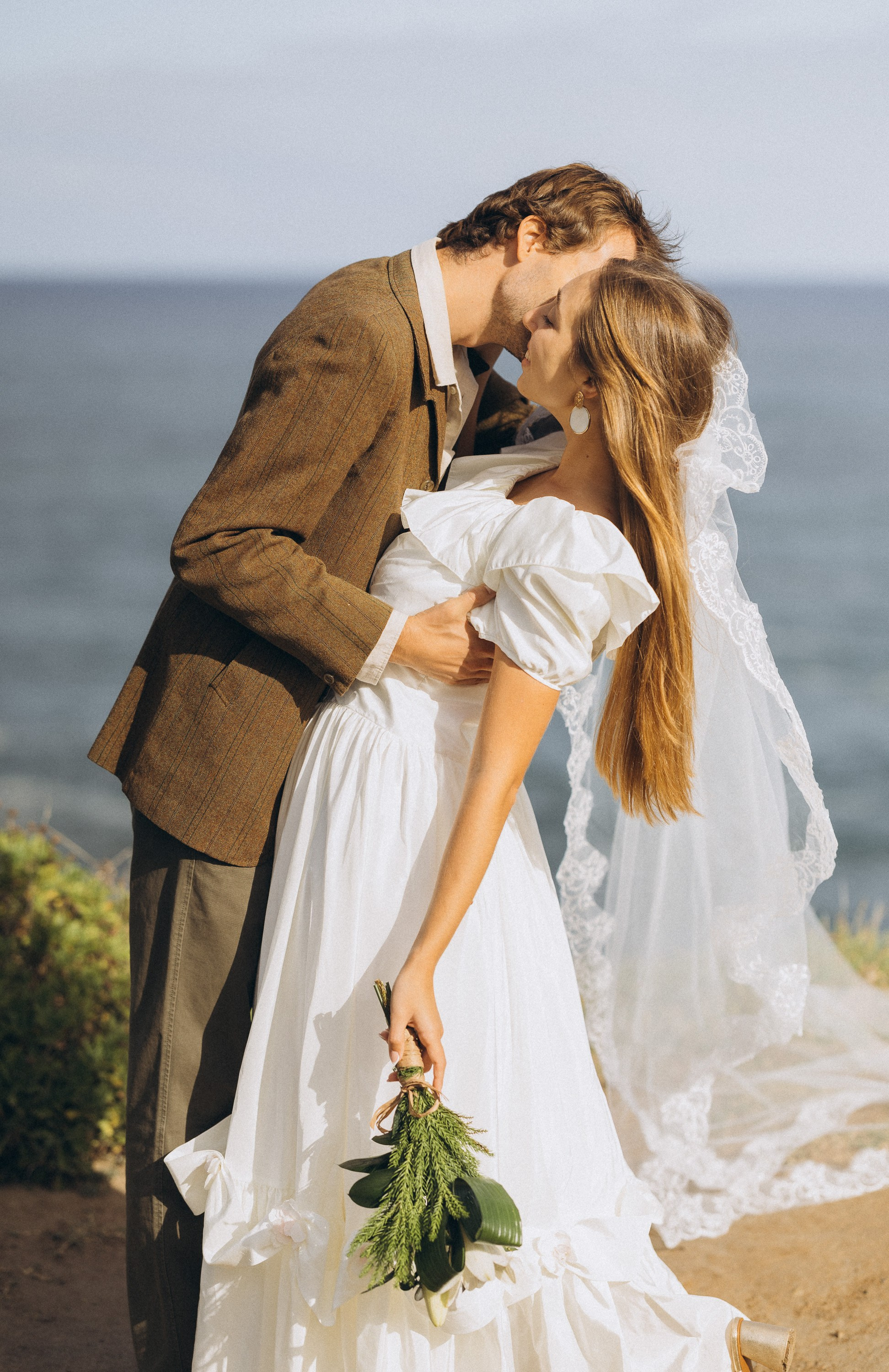 Romantic elopement in Madeira — couple exchanging vows with Atlantic Ocean views.