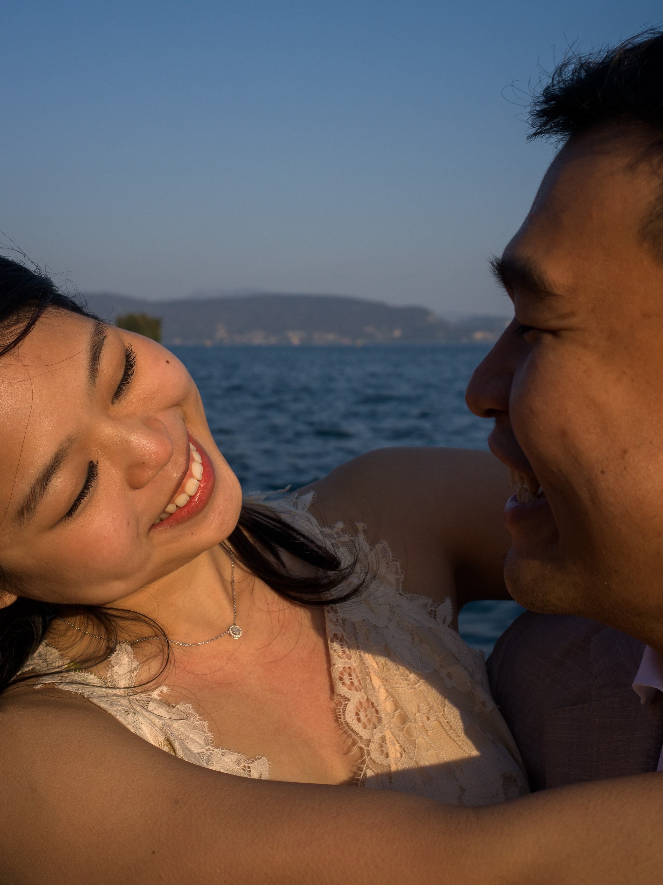 Engagement photo of couple with Isola del Garda backdrop.