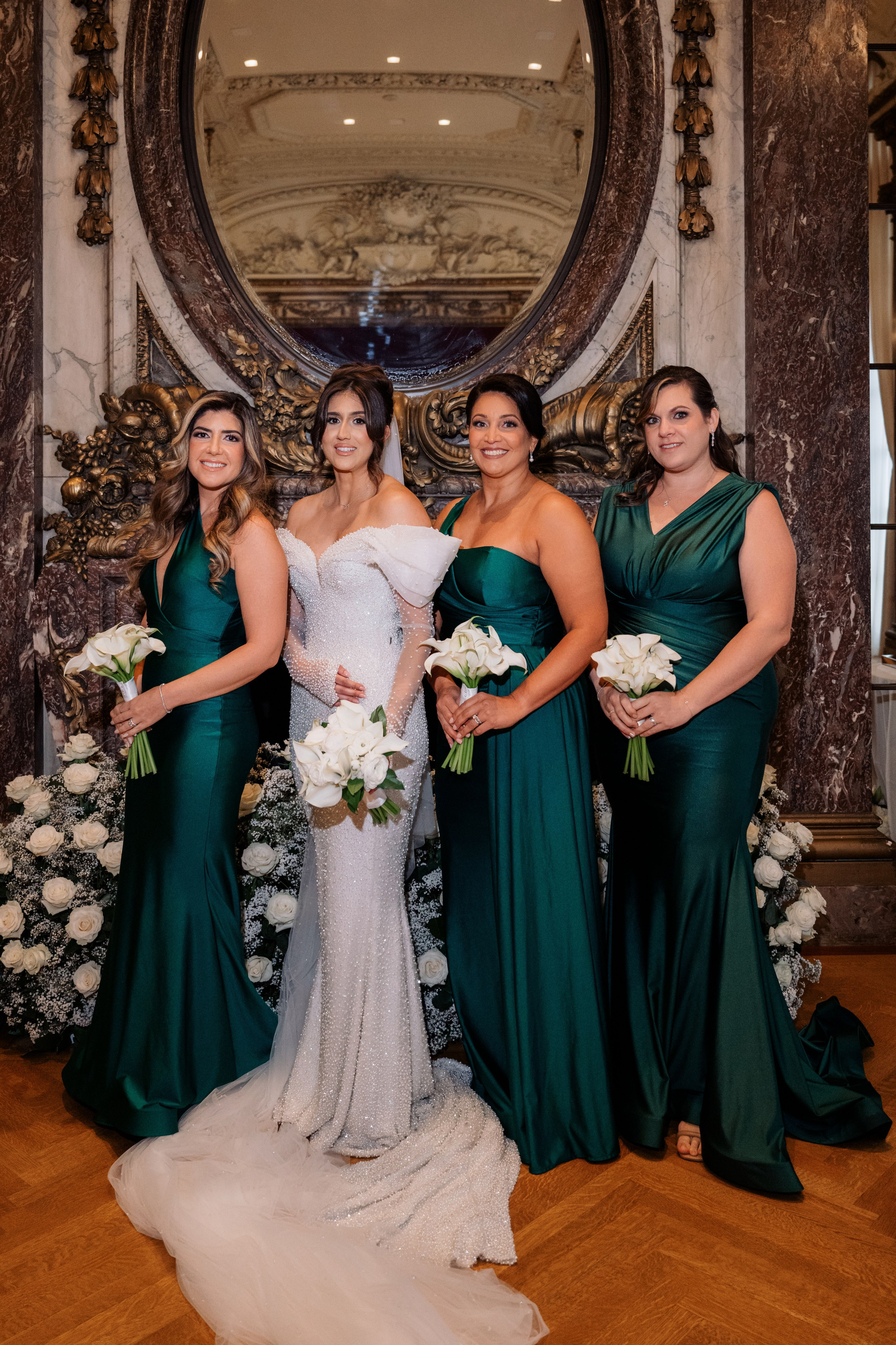 a bride and her bridesmaids pose for a photo
