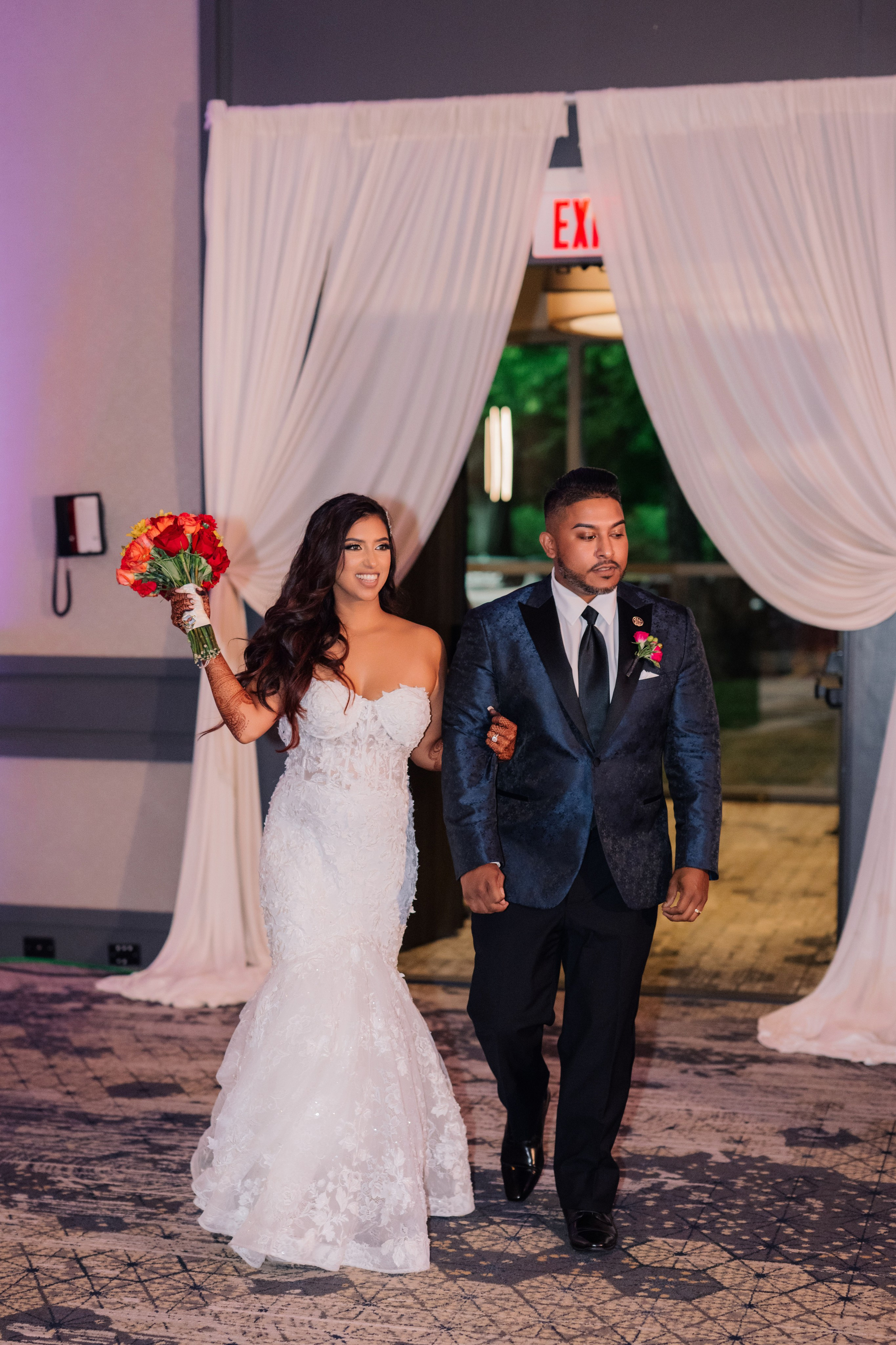 a bride and groom walking down the aisle