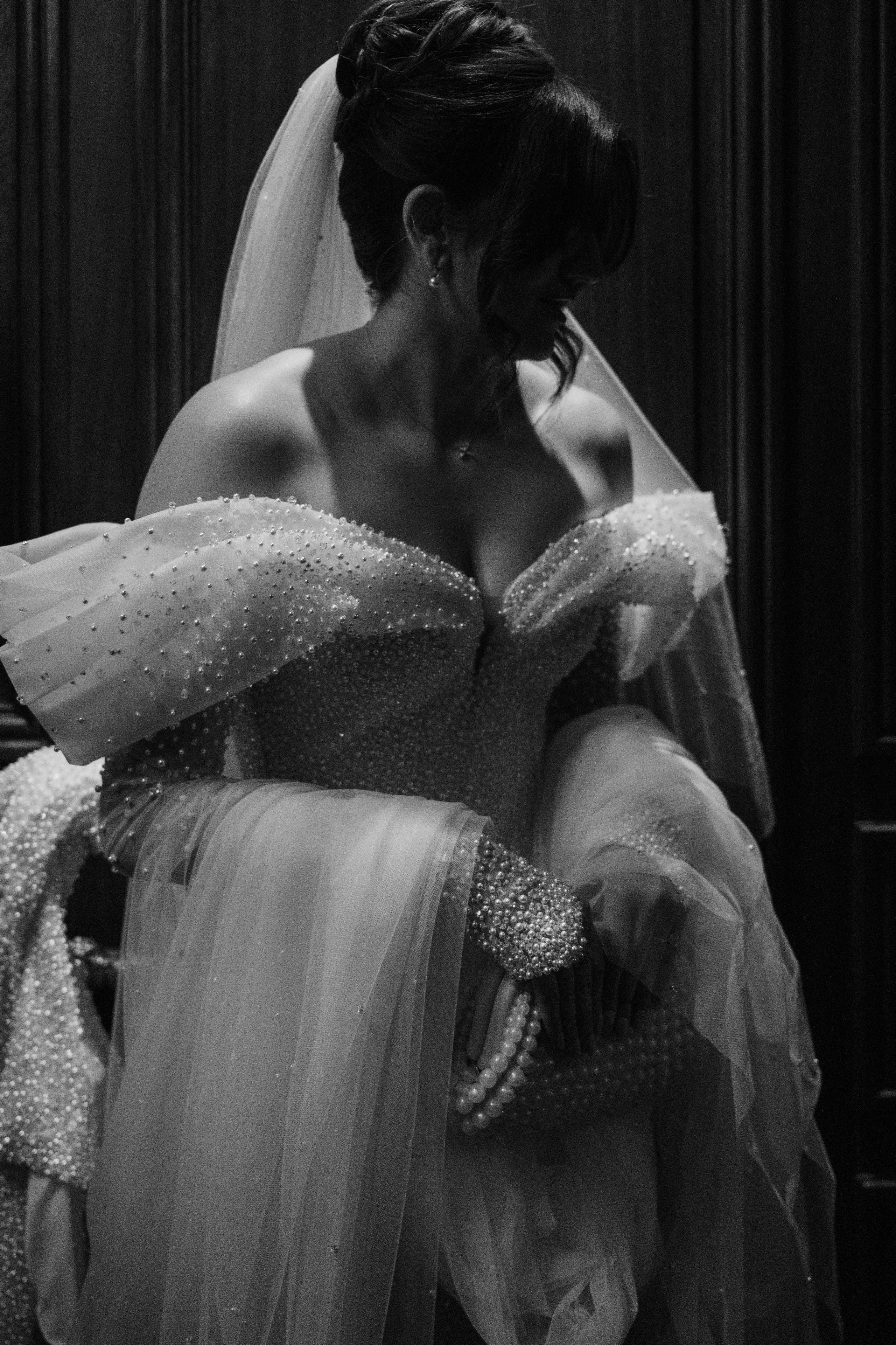 a woman in a wedding dress is sitting down