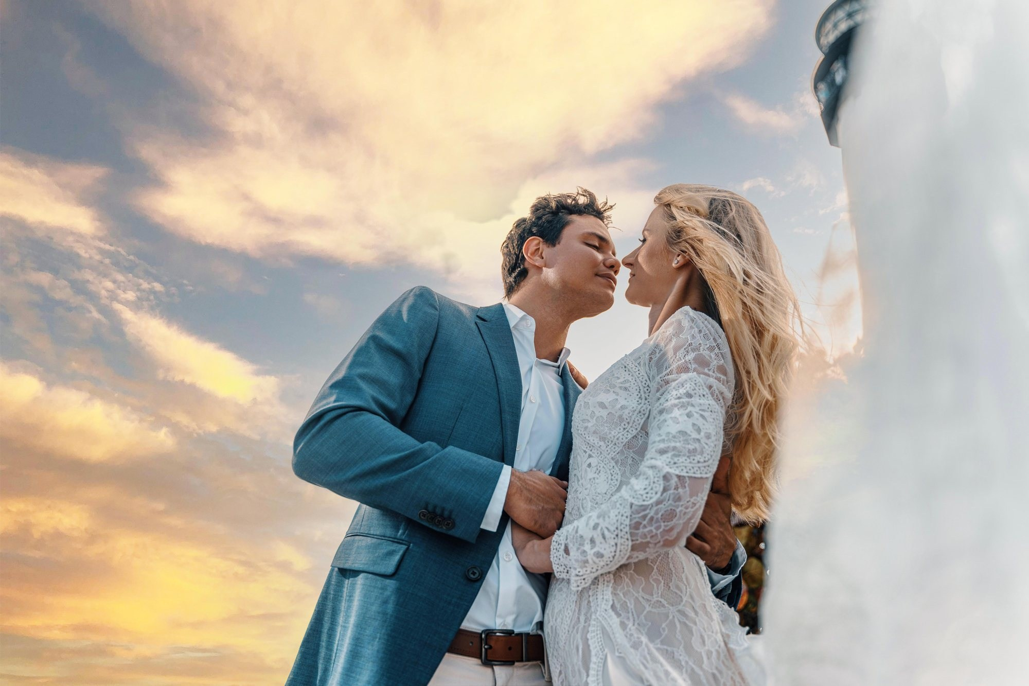 Miami beach wedding photographer — couple under a dramatic sunset sky