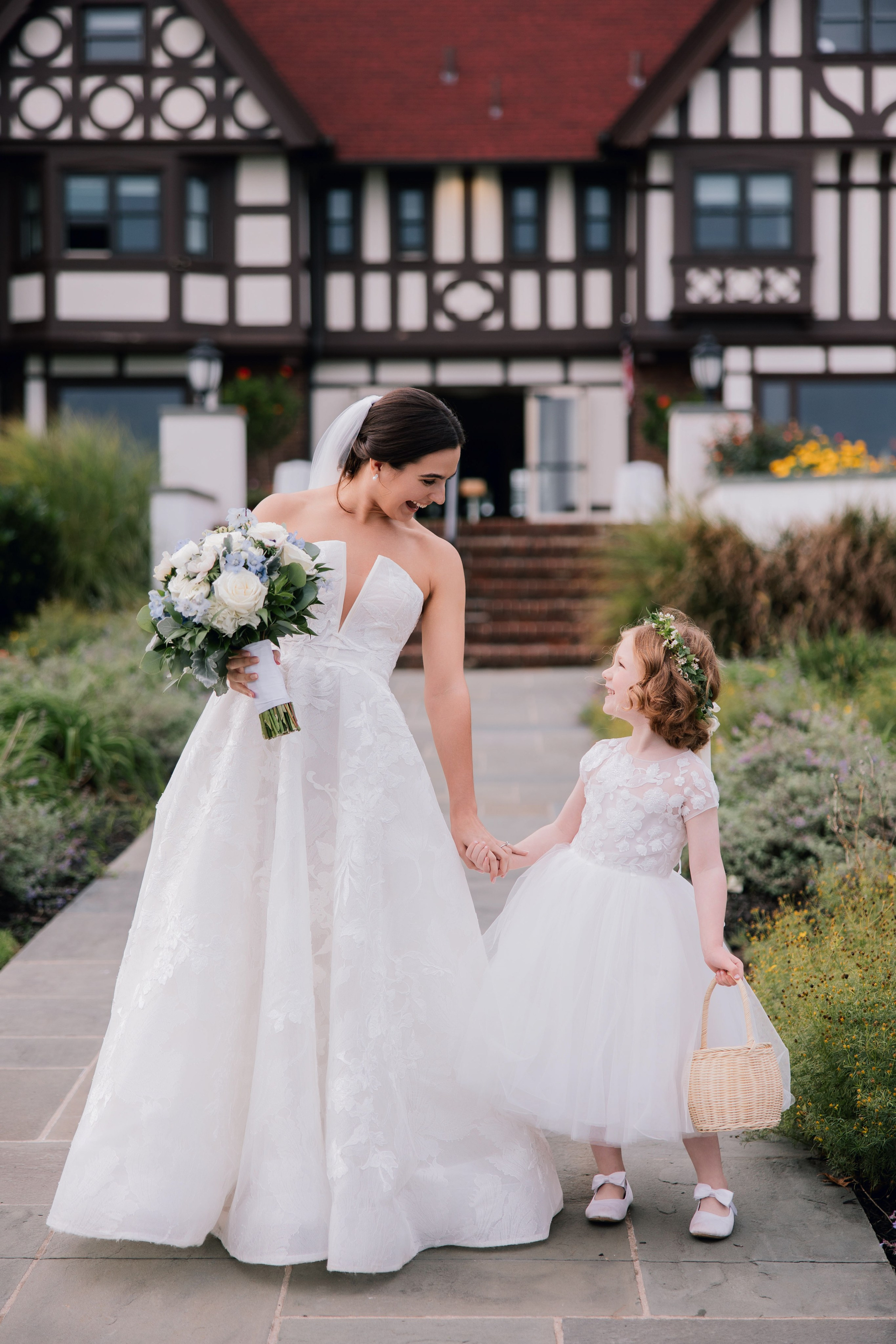 a bride and her flower girl walking down the aisle