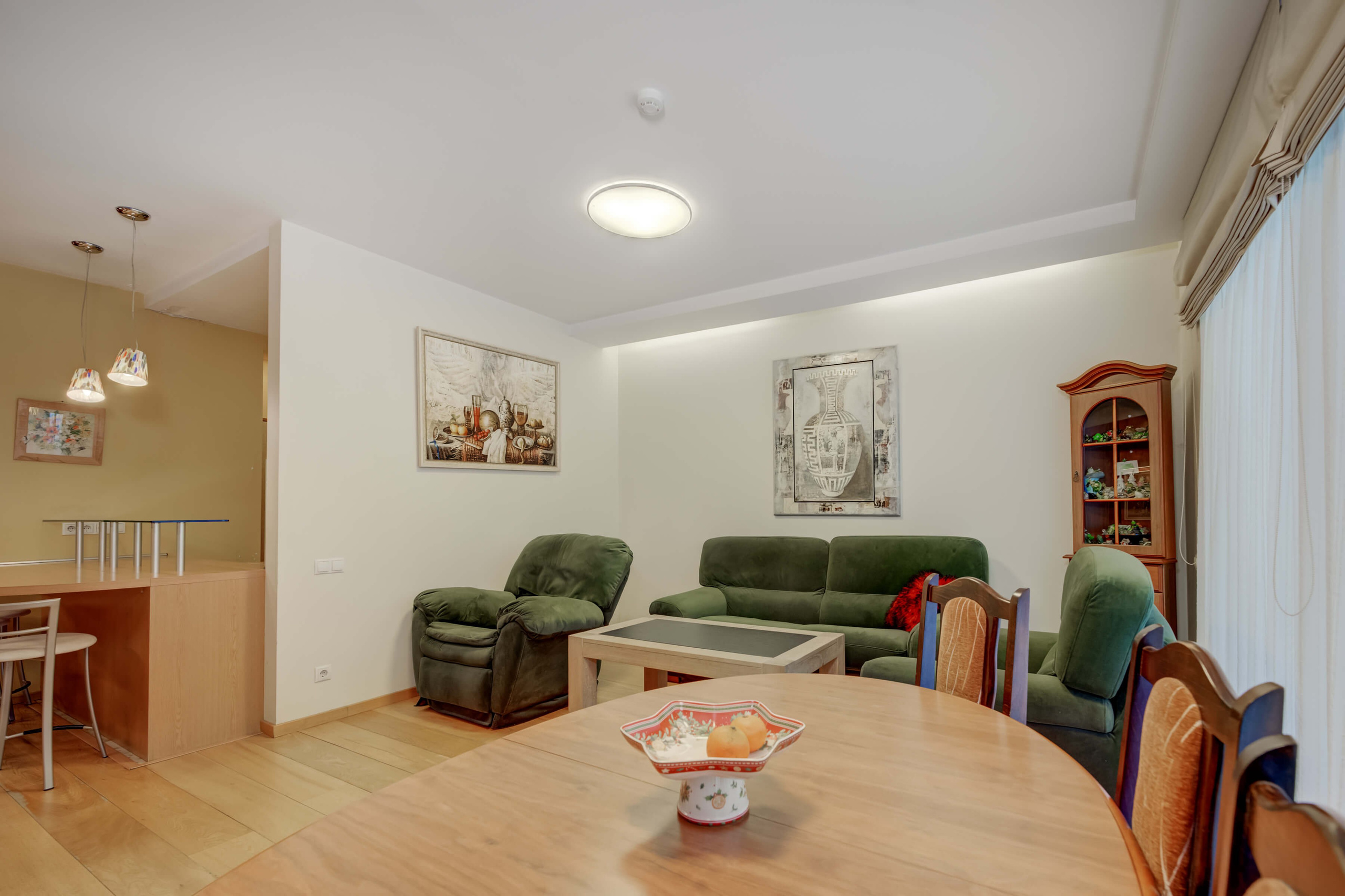 Svetainė su išėjimu į terasą ir meno kūriniais 4 kambarių prabangiame bute Vilniuje prie miško