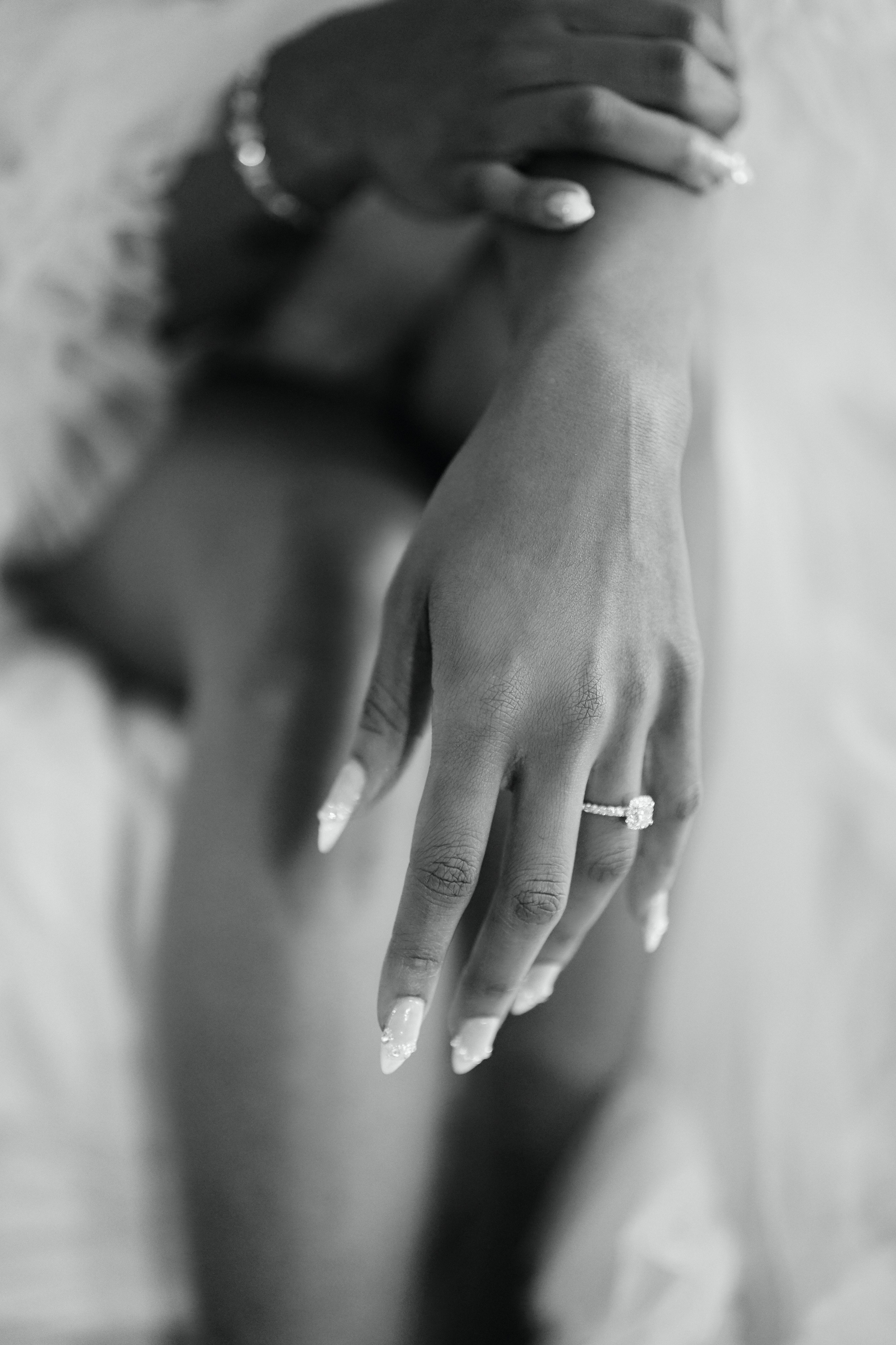 Elegant black and white wedding photography showing bride and groom rings