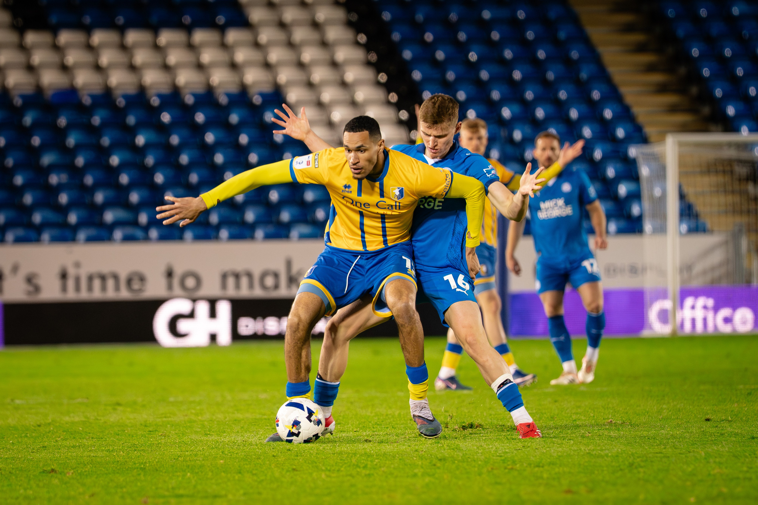 Peterborough United and Mansfield Town players battling for possession during the League One fixture at the Weston Homes Stadium.
