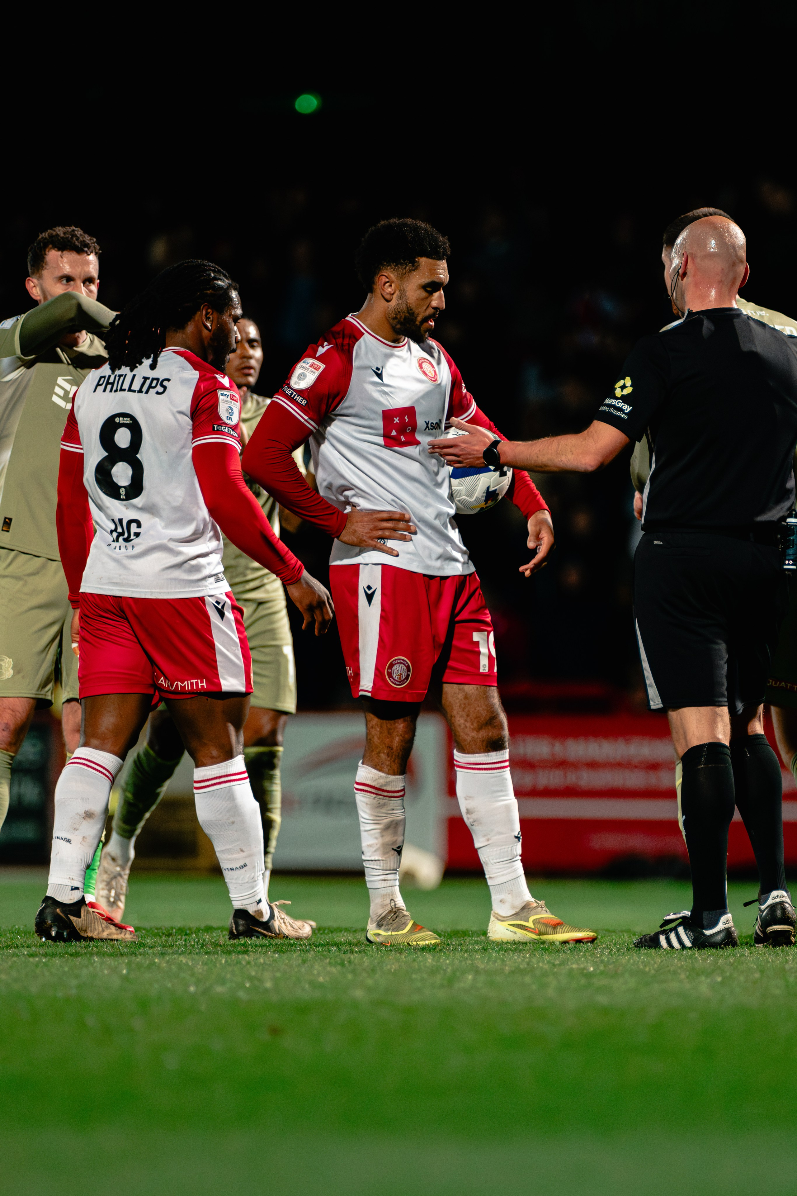 Stevenage players gathered near the touchline during the League One fixture against Leyton Orient.