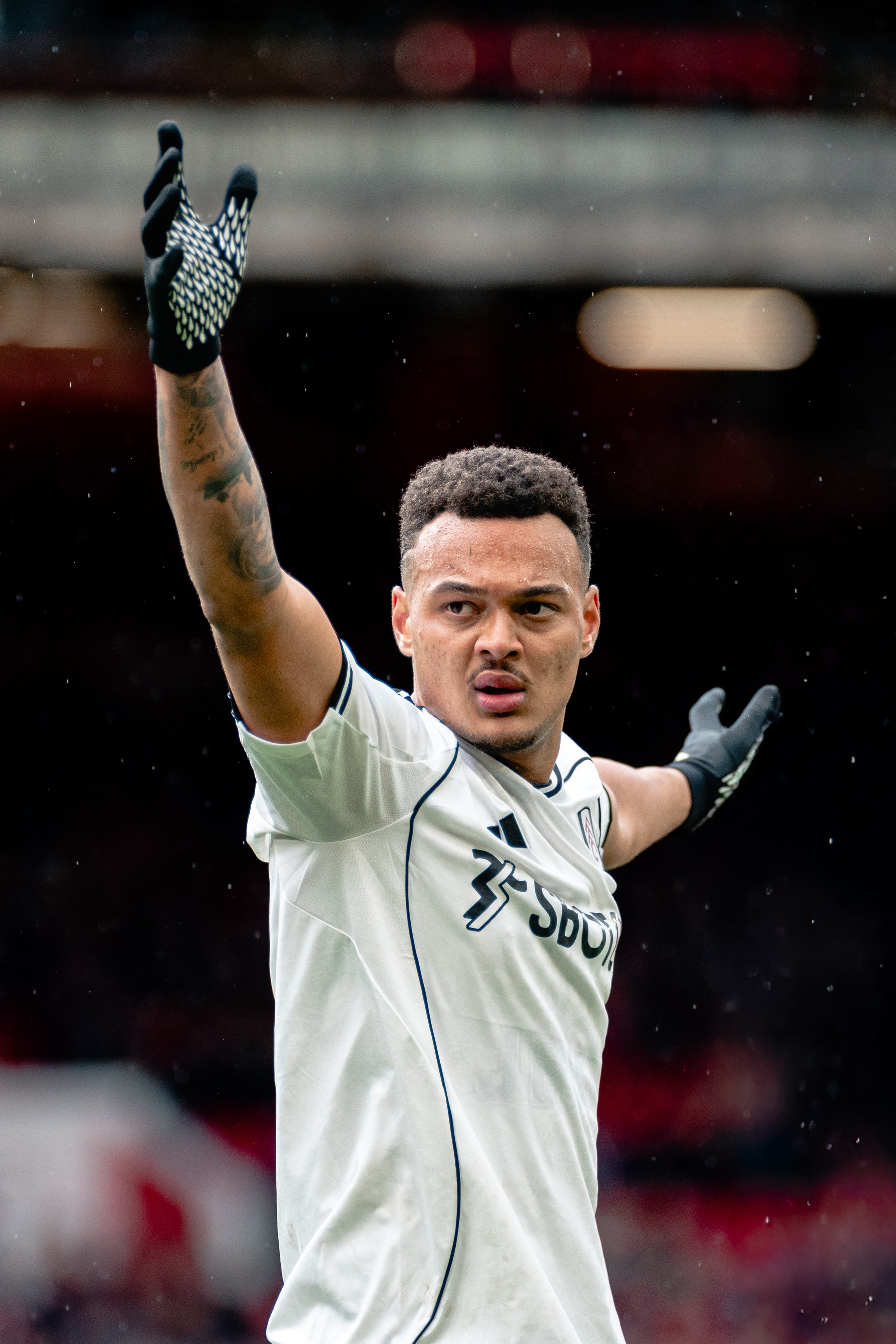 Fulham player raising his hand during the Premier League fixture against Nottingham Forest at the City Ground.